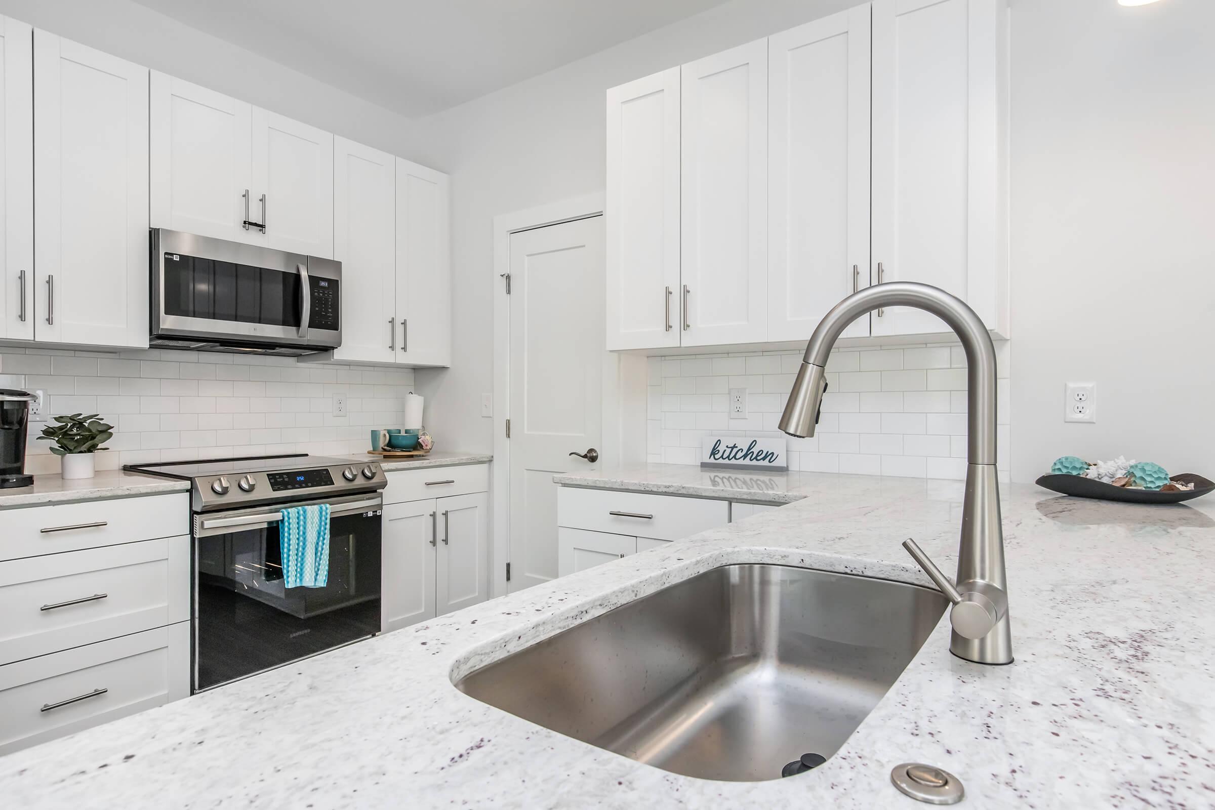 a kitchen with a sink and a microwave