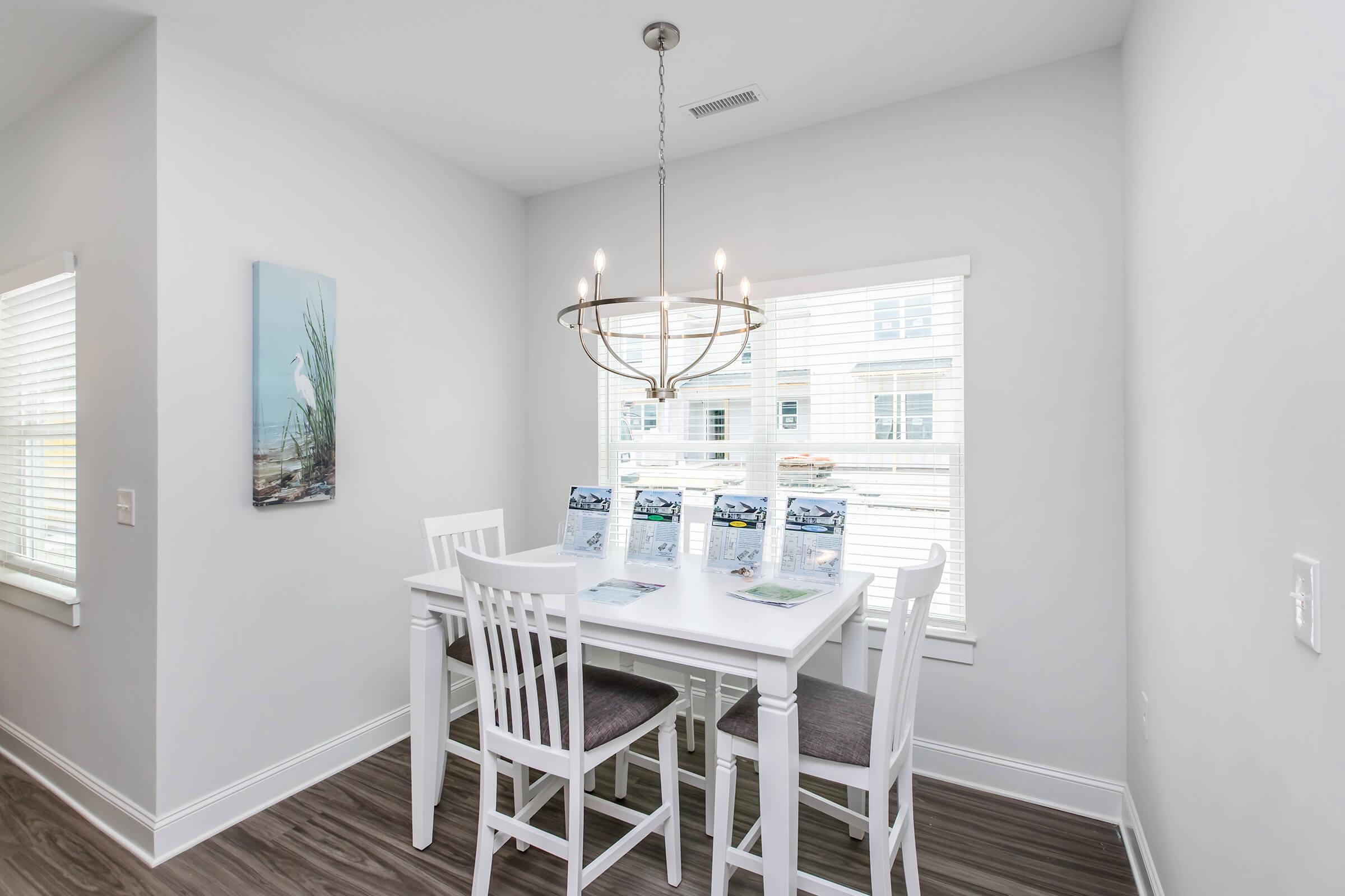 a kitchen with a sink and a chair in a room