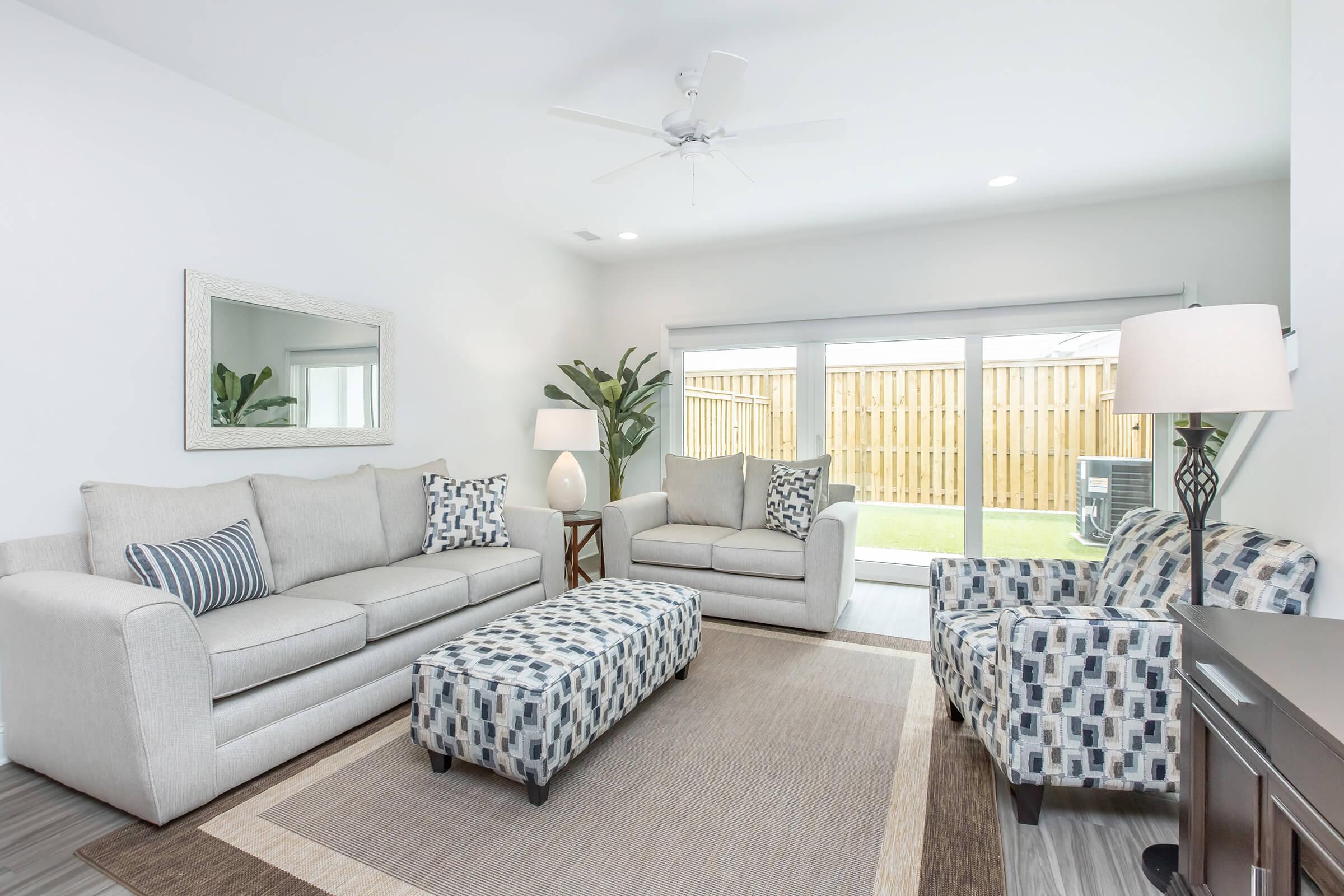 a living room filled with furniture and a bed