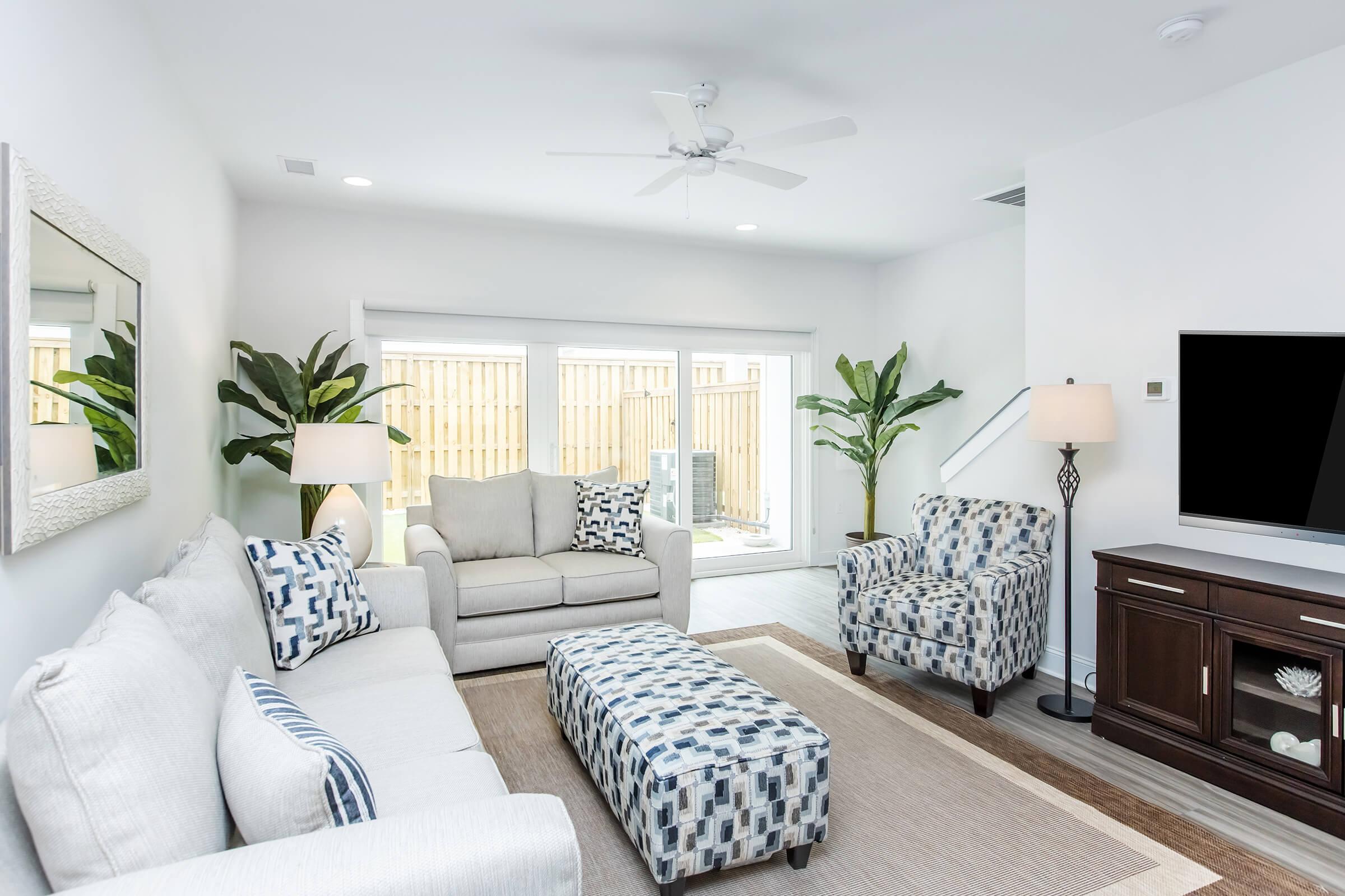 a living room filled with furniture and a flat screen tv