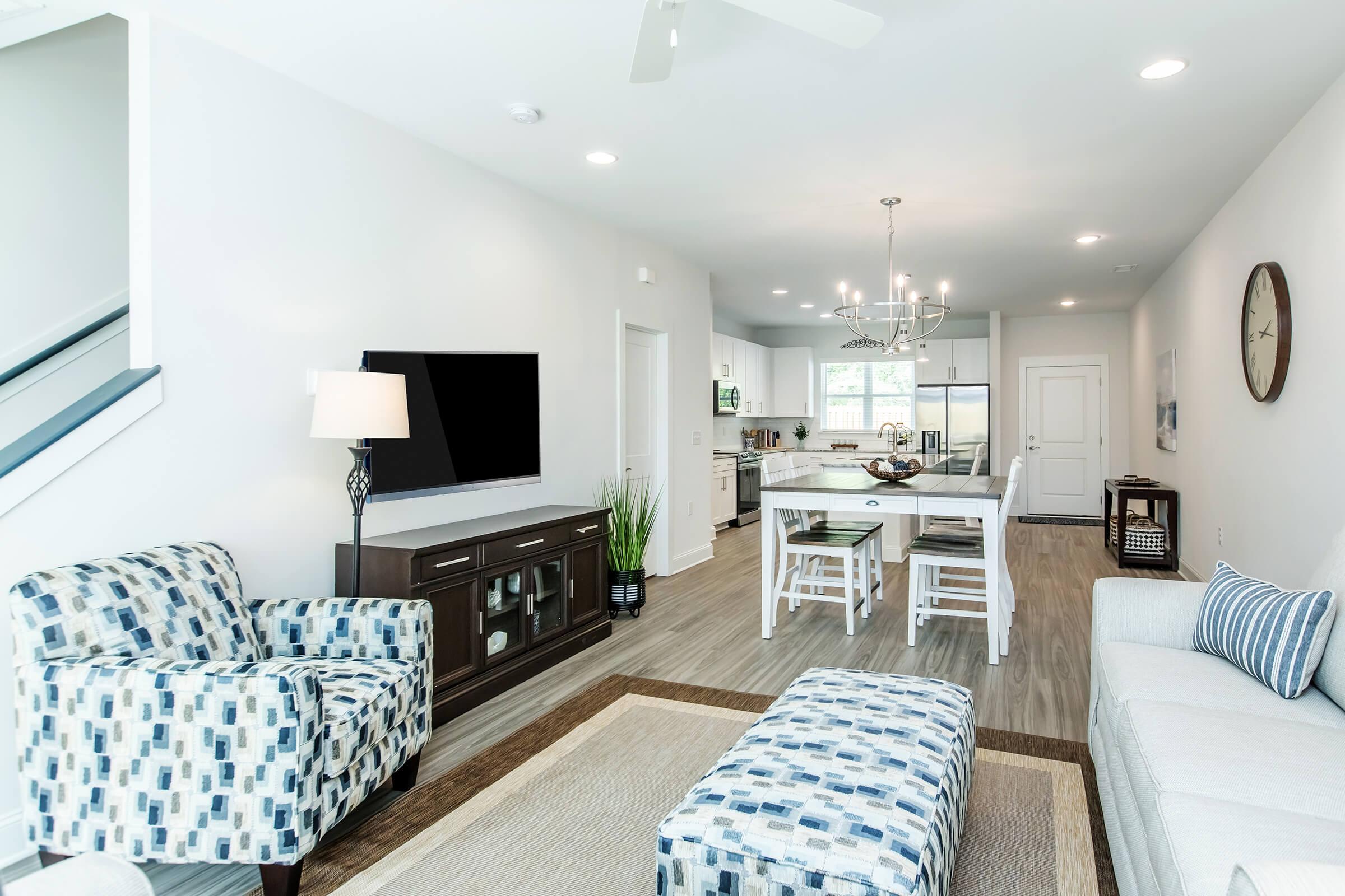 a living room filled with furniture and a flat screen tv