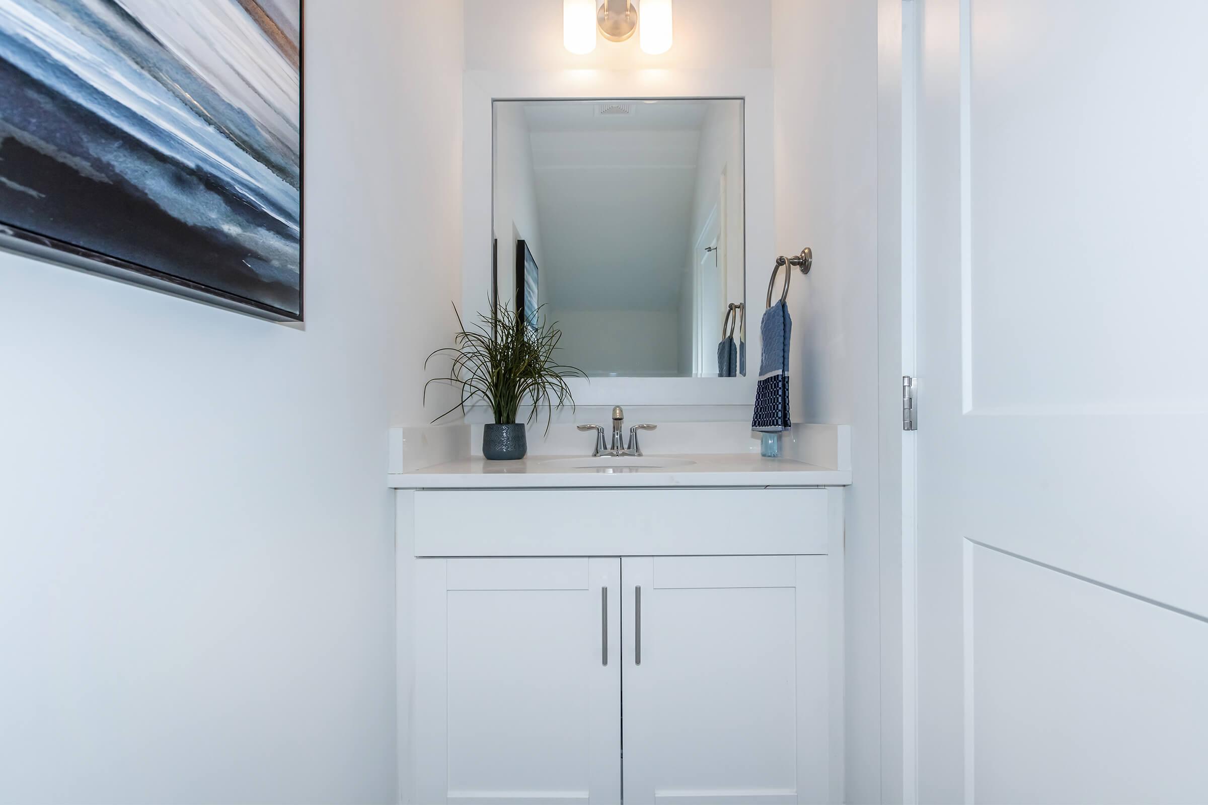 a kitchen with a sink and a mirror