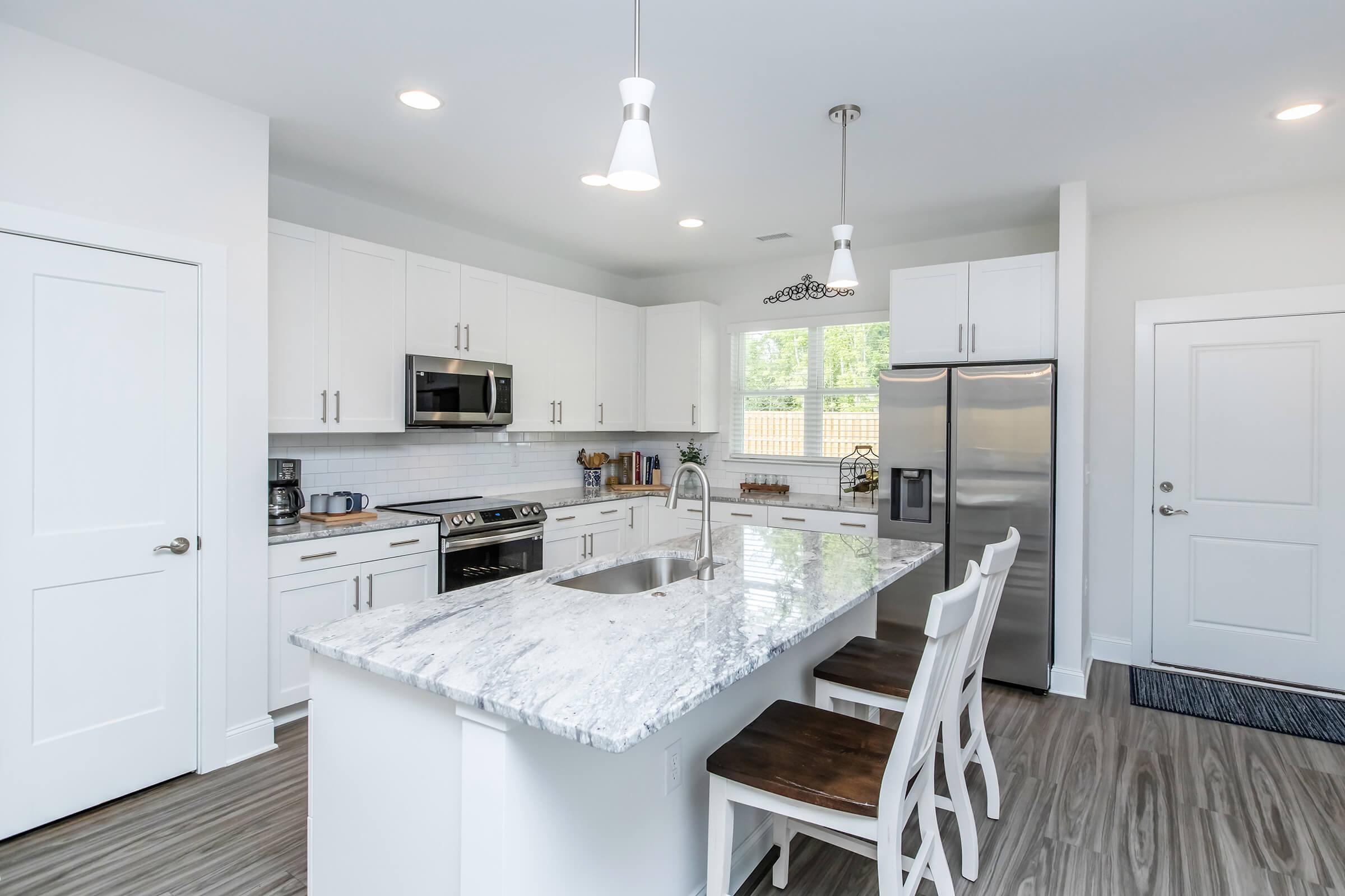 a kitchen with an island in the middle of a room