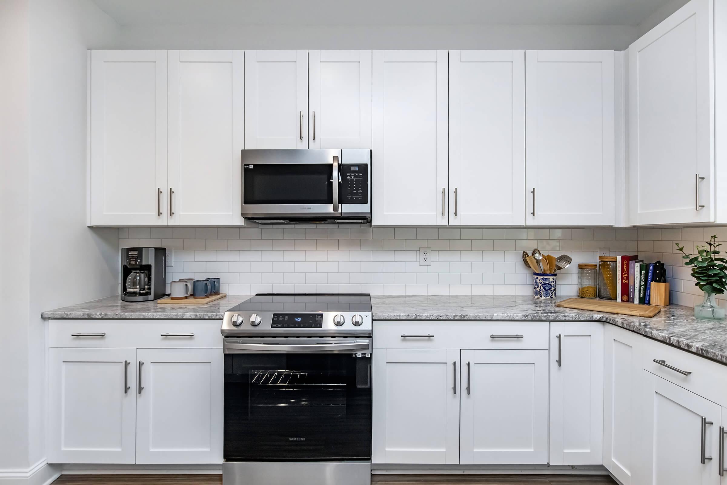 a stove top oven sitting inside of a kitchen