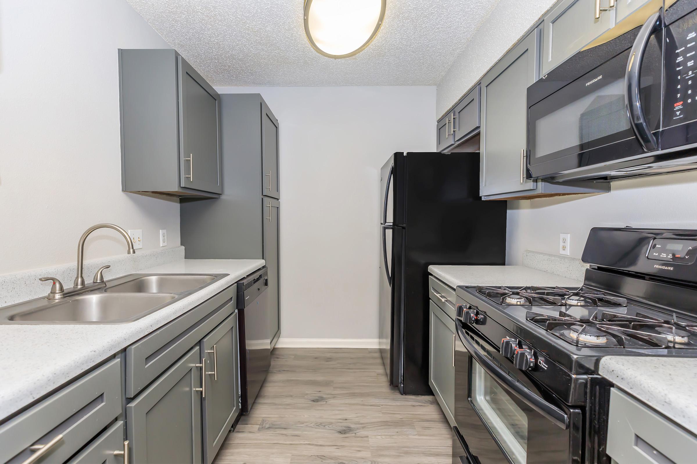 a kitchen with a stove and a sink