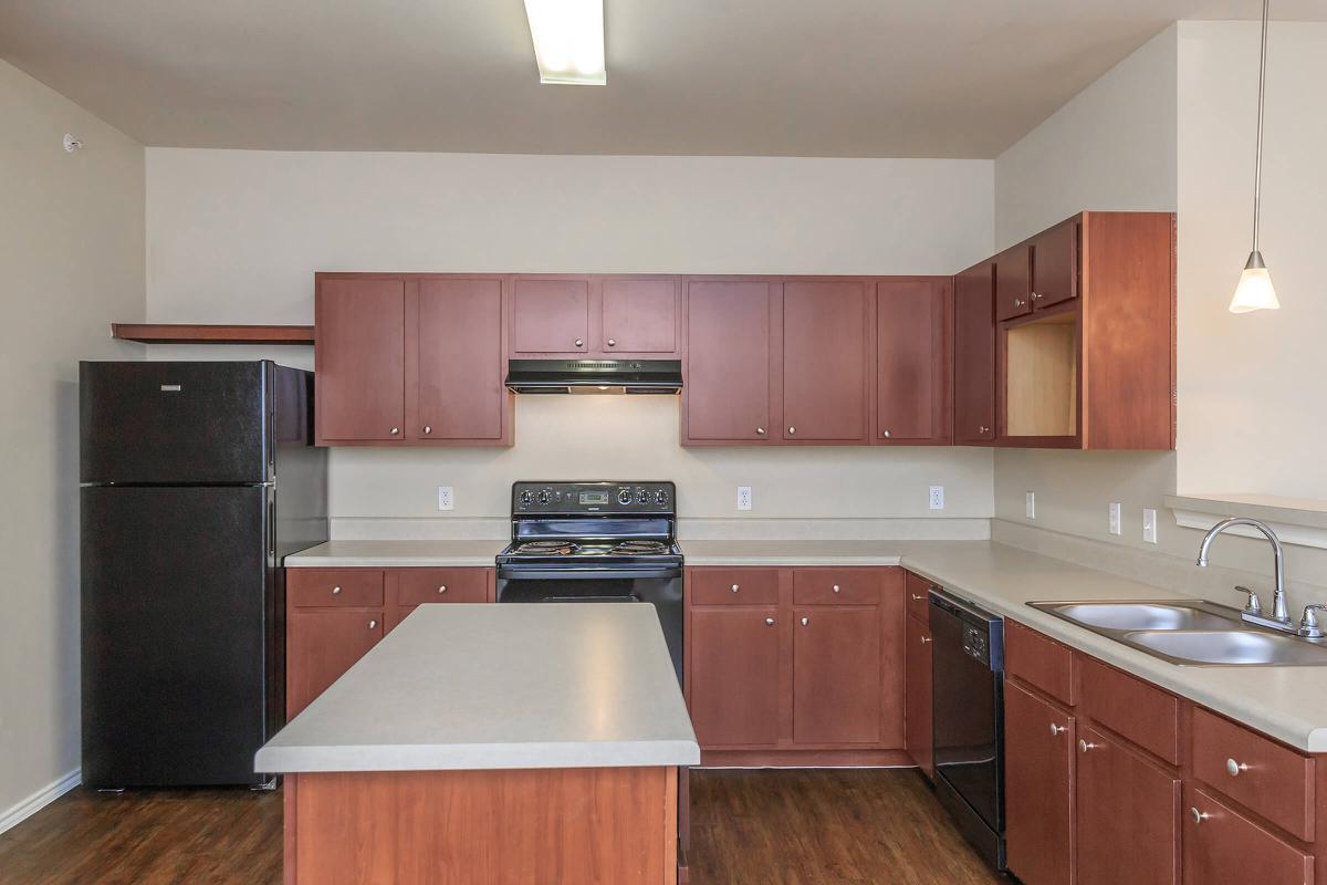 a kitchen with stainless steel appliances and wooden cabinets