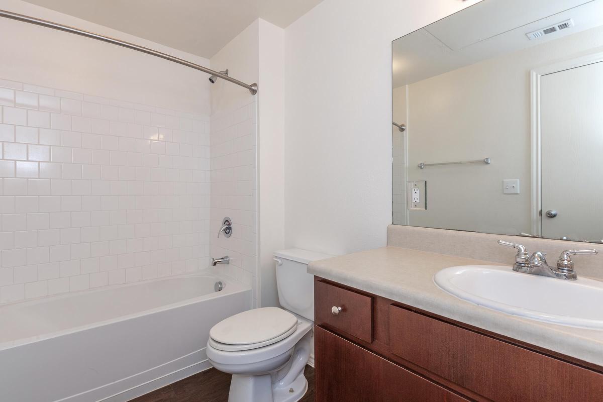 a white sink sitting next to a shower