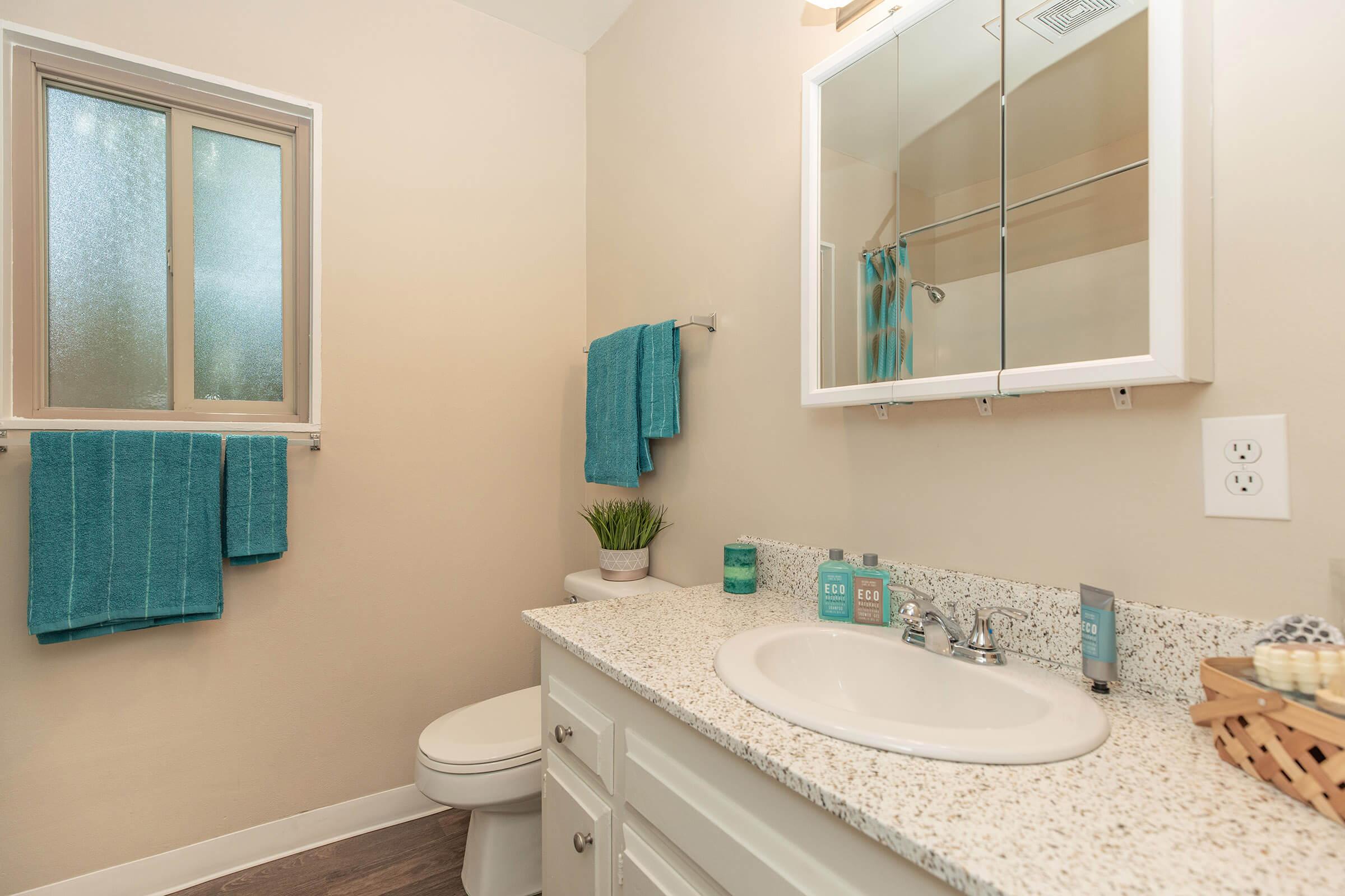 a bedroom with a green tub and sink