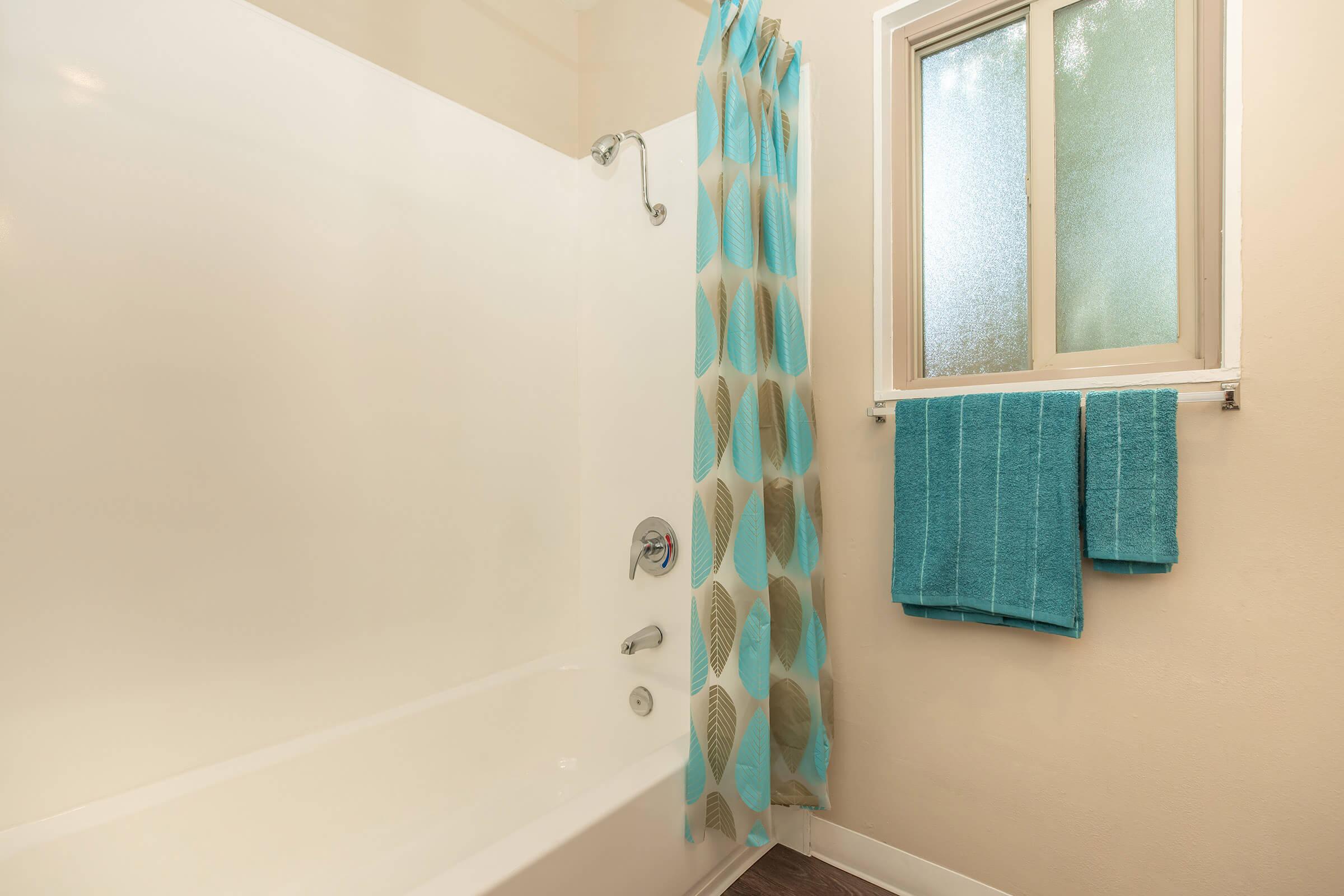 a white tub sitting next to a window