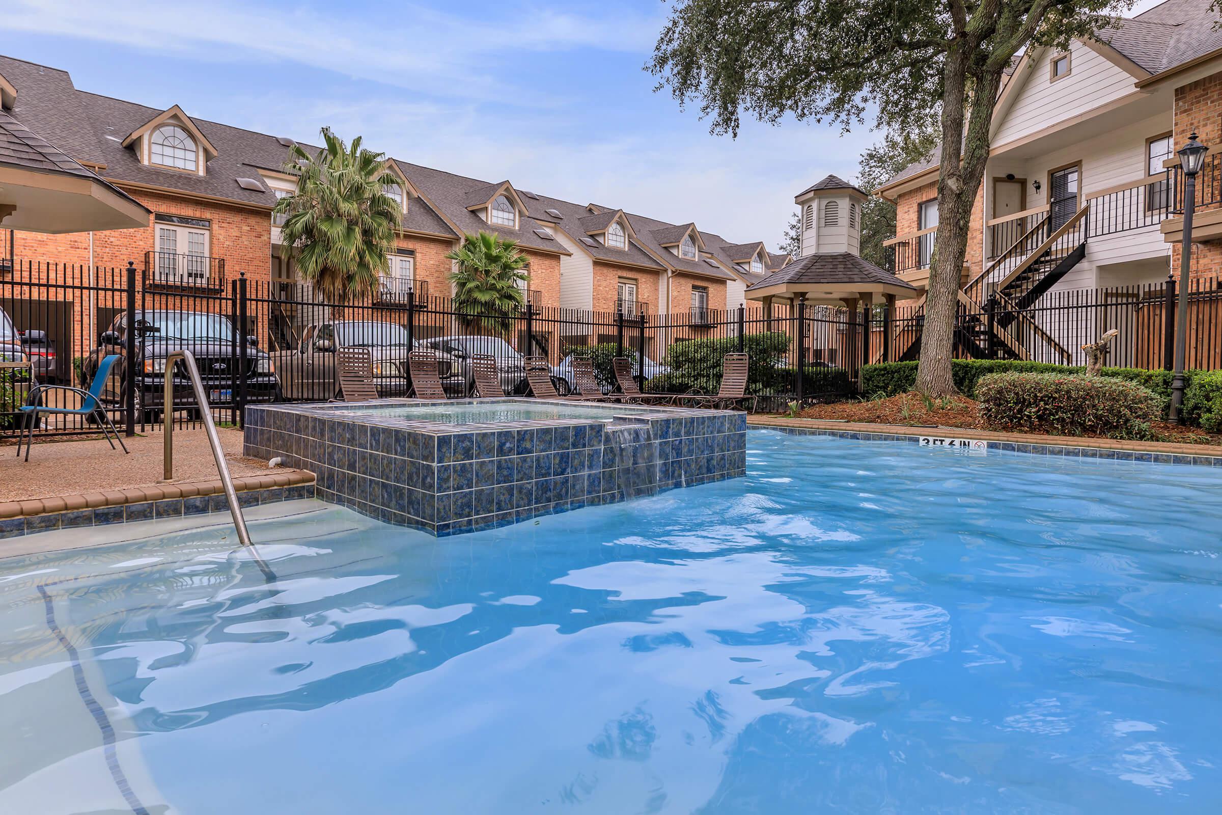 a large pool of water in front of a house