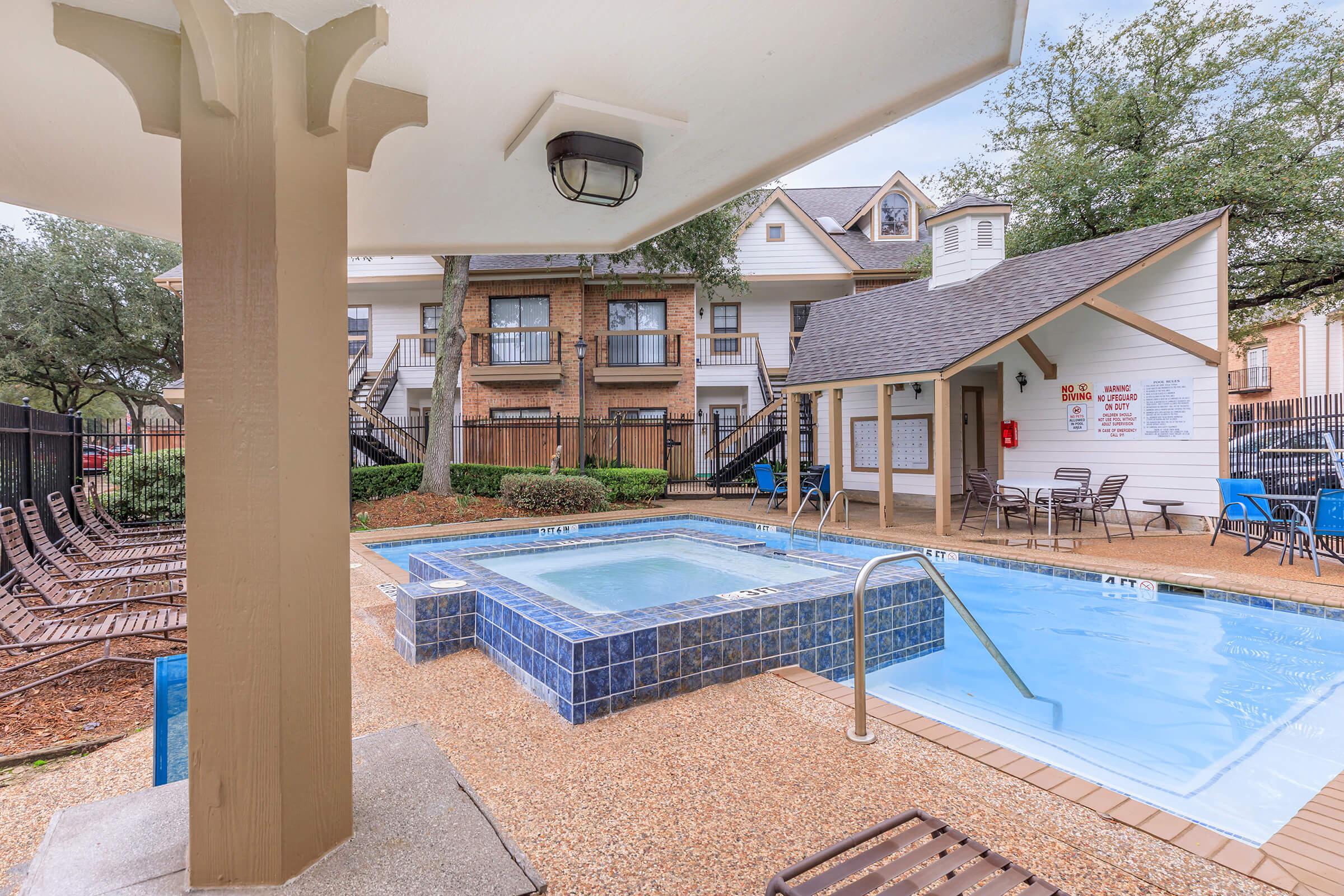 a house with a pool in front of a building