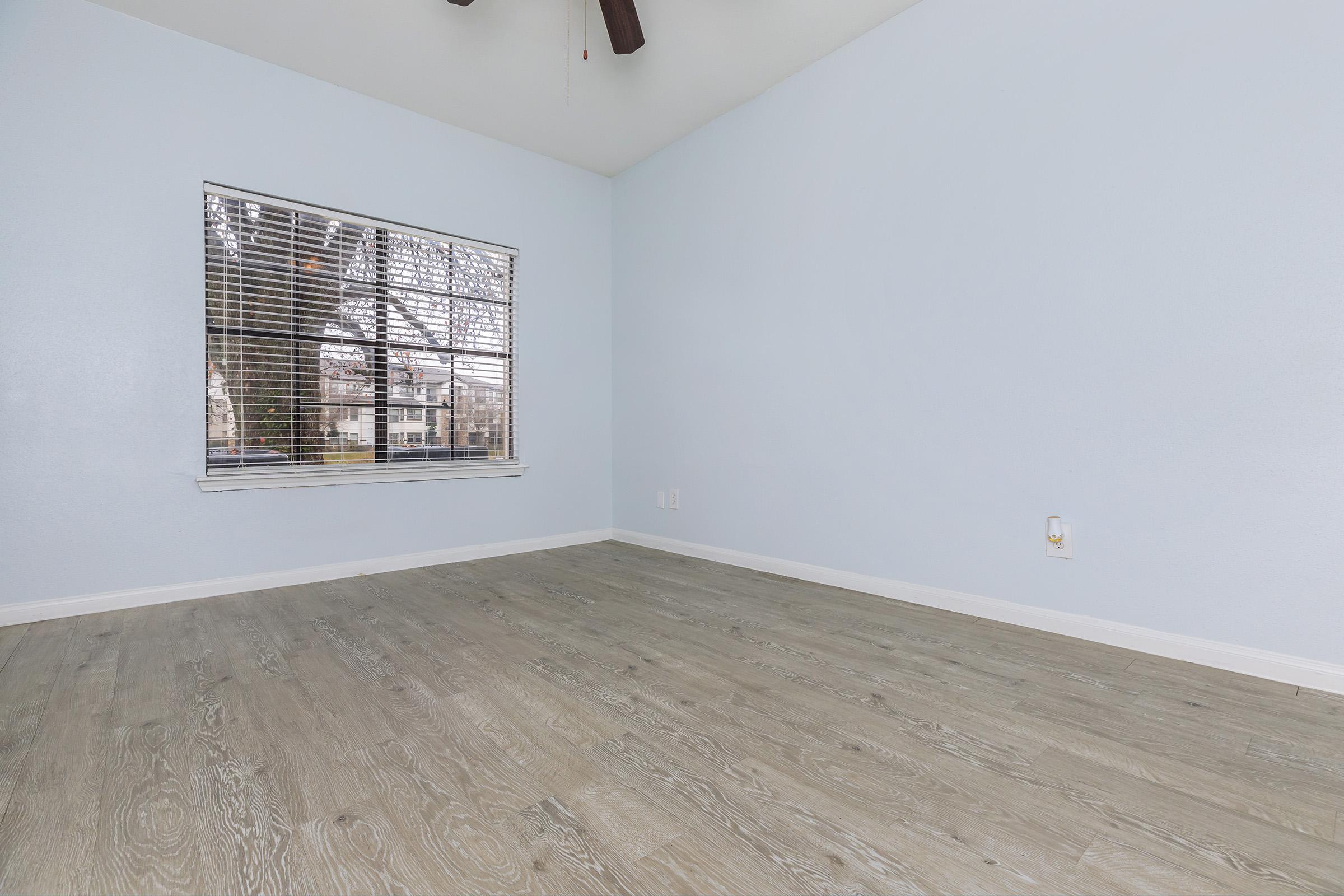 a bedroom with a building in the background