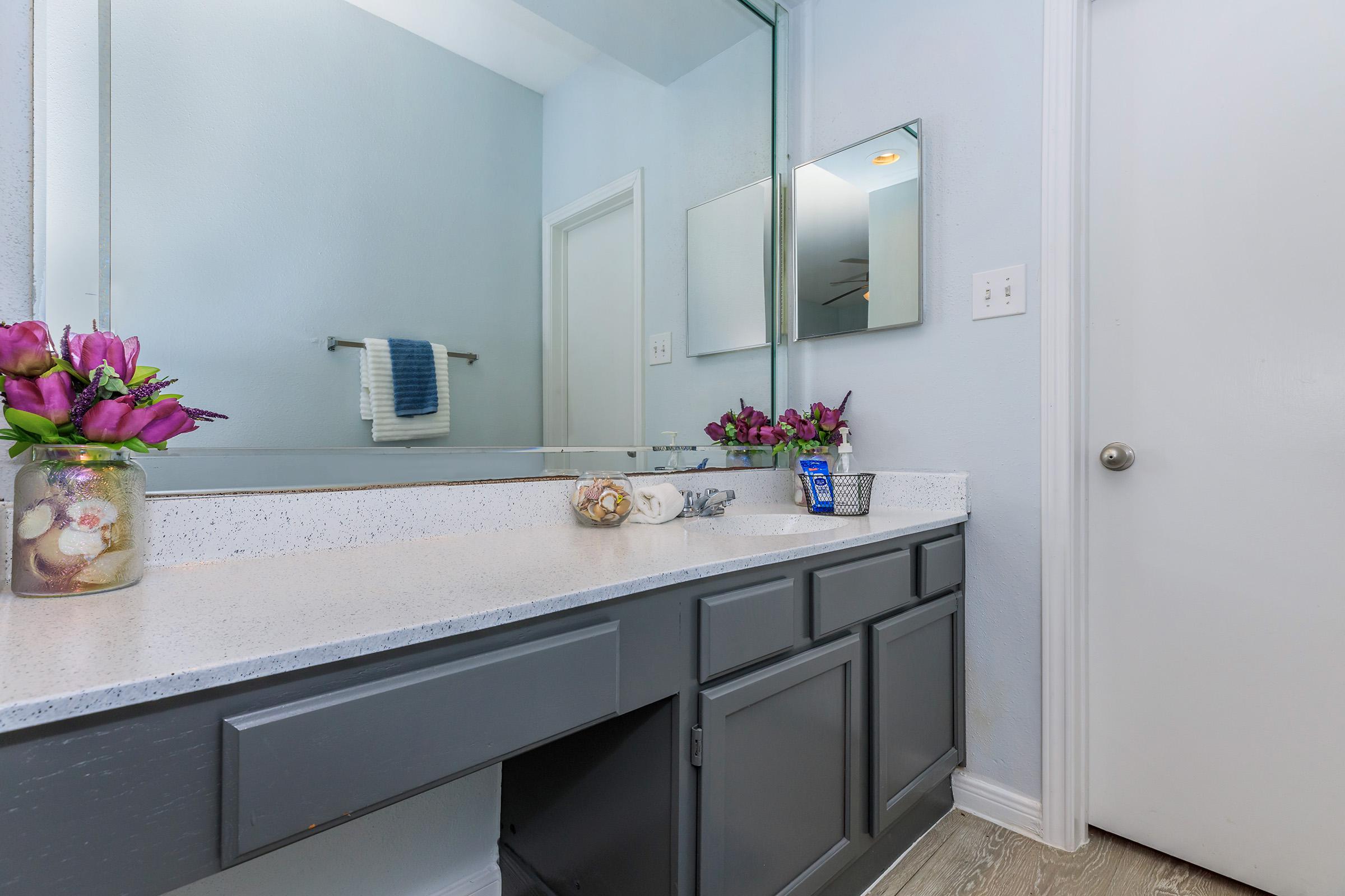 a kitchen with a sink and a mirror