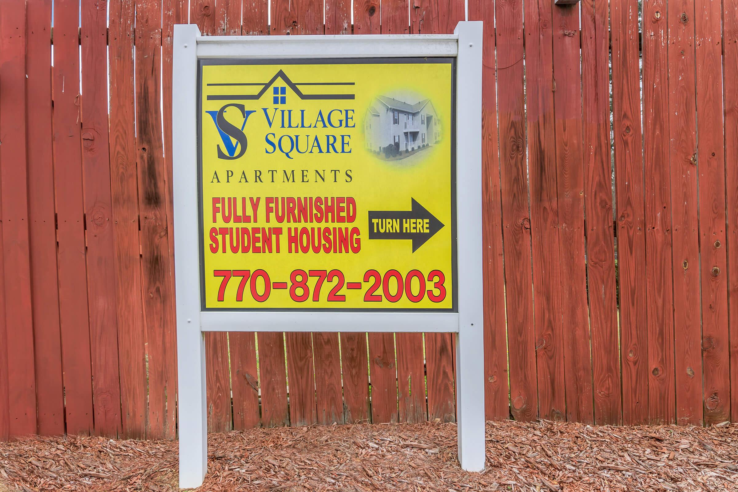 a sign on the side of a wooden door