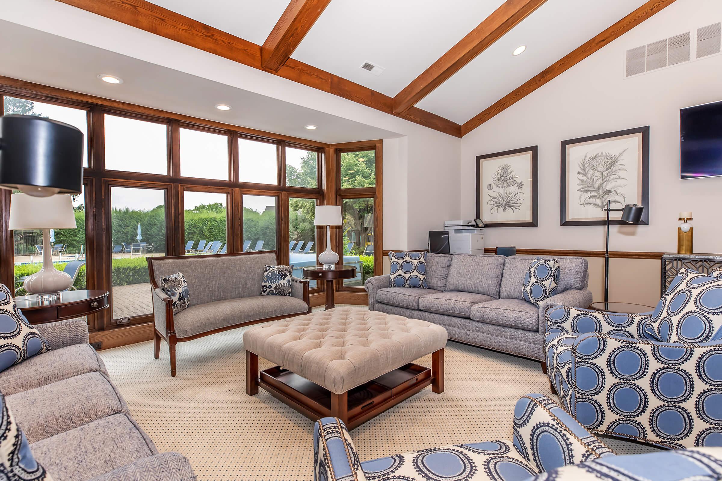 a living room filled with furniture and a large window