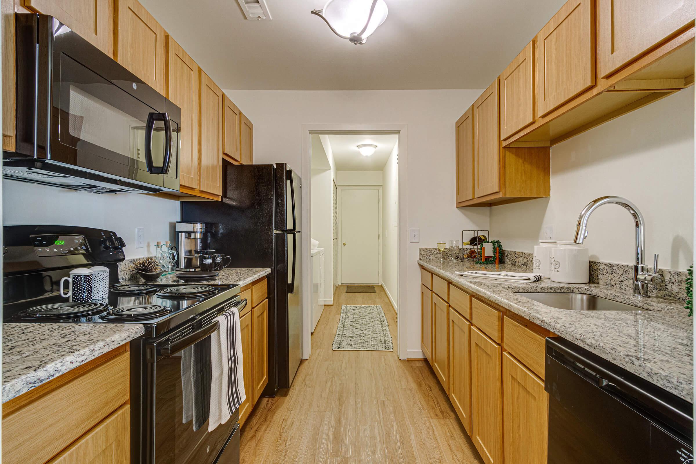 a kitchen with stainless steel appliances and wooden cabinets