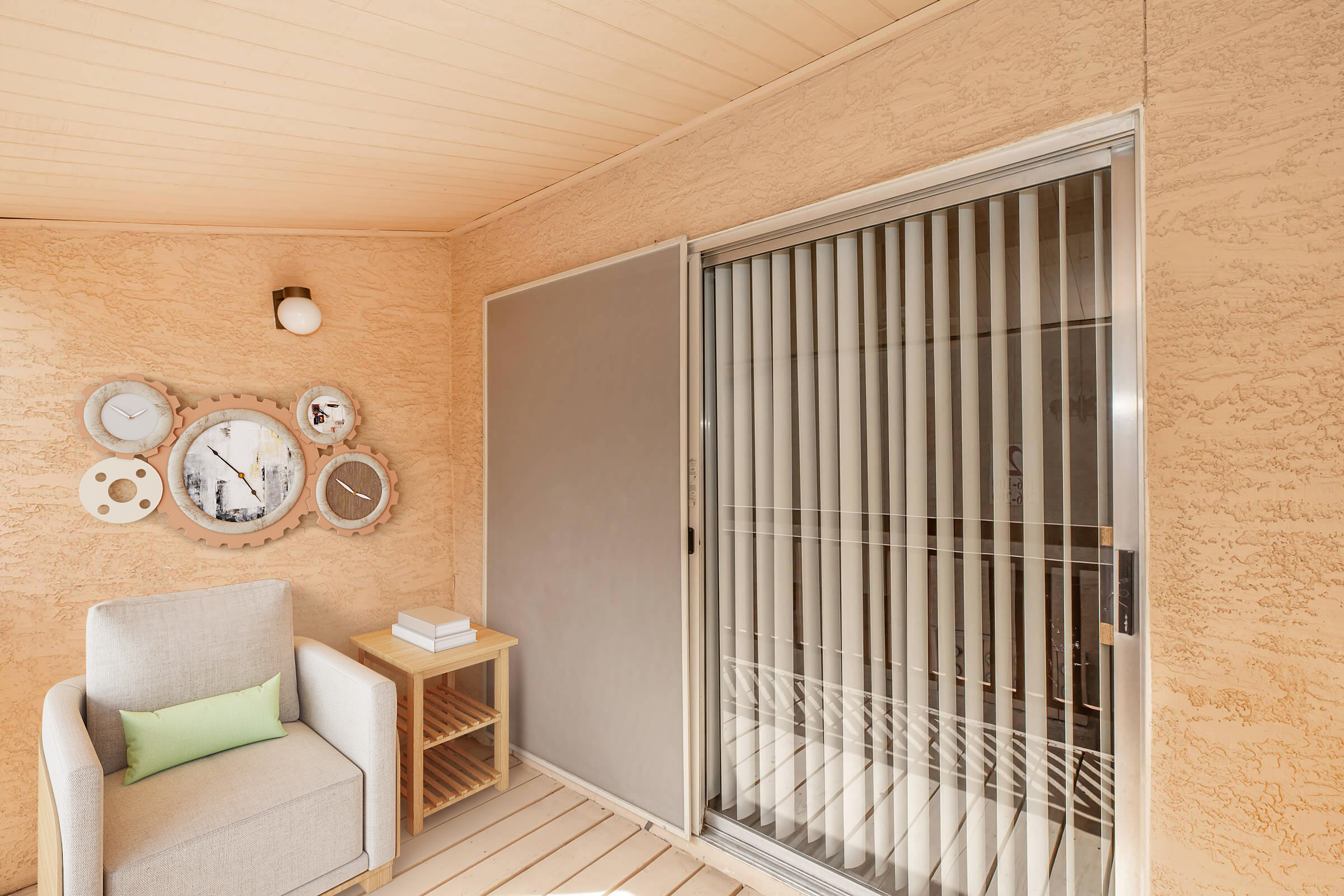 A cozy indoor space featuring a soft armchair with a green accent pillow next to a small wooden side table. On the wall, several decorative clocks are arranged artistically. A sliding glass door with vertical blinds leads outside, allowing natural light to enter the room. The color palette is warm and inviting.