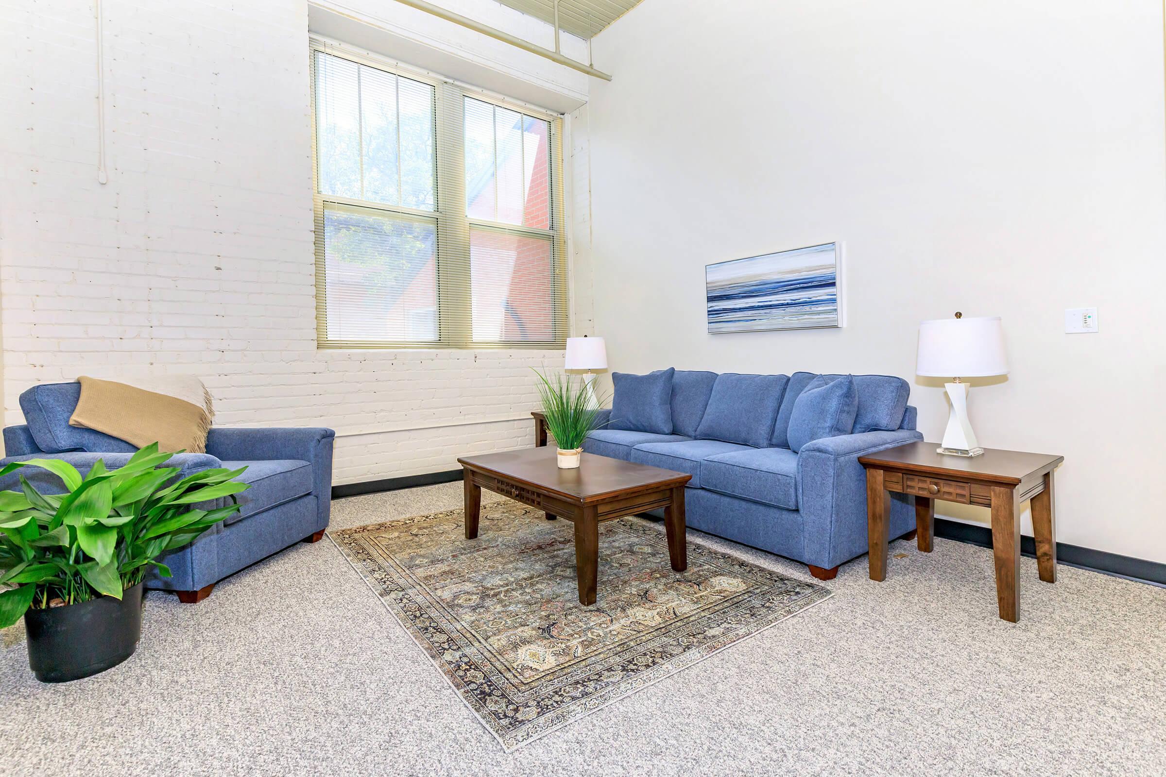 a living room filled with furniture and a window