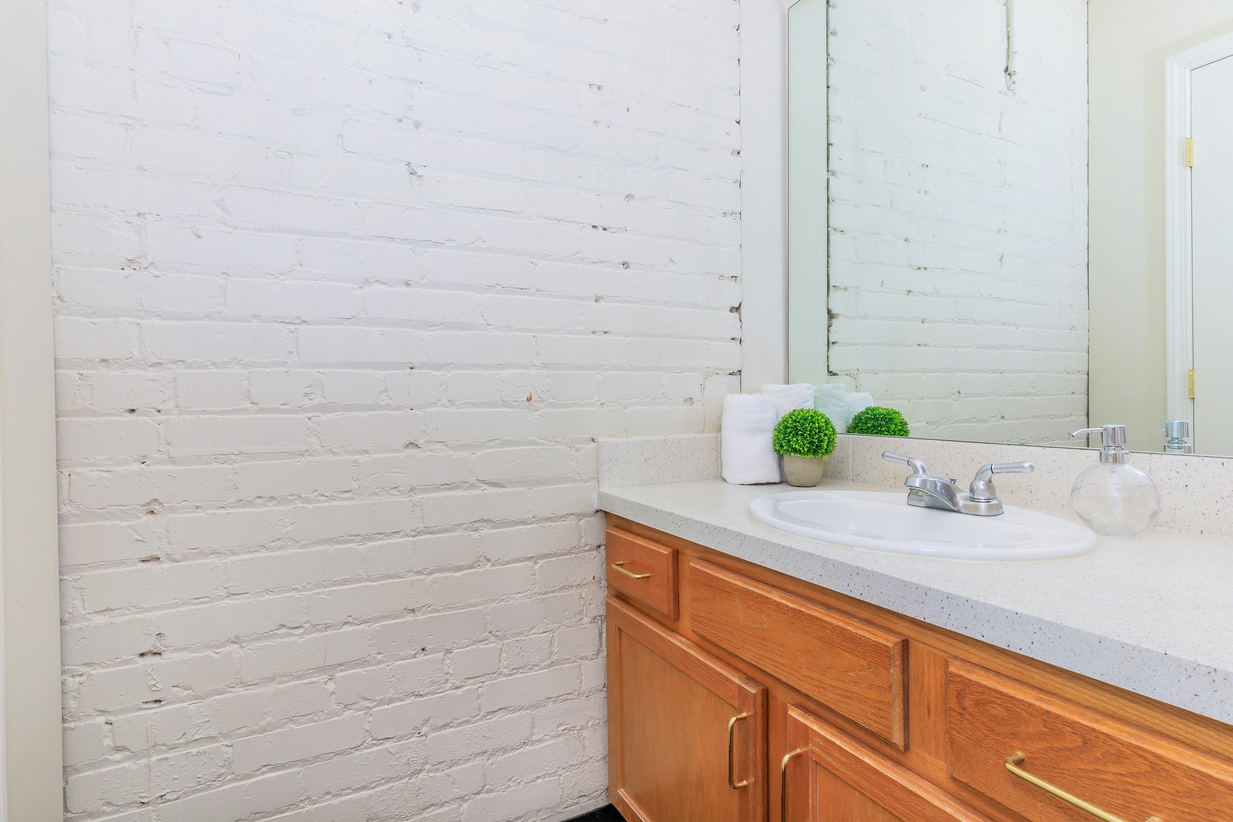 a room with a sink and a mirror