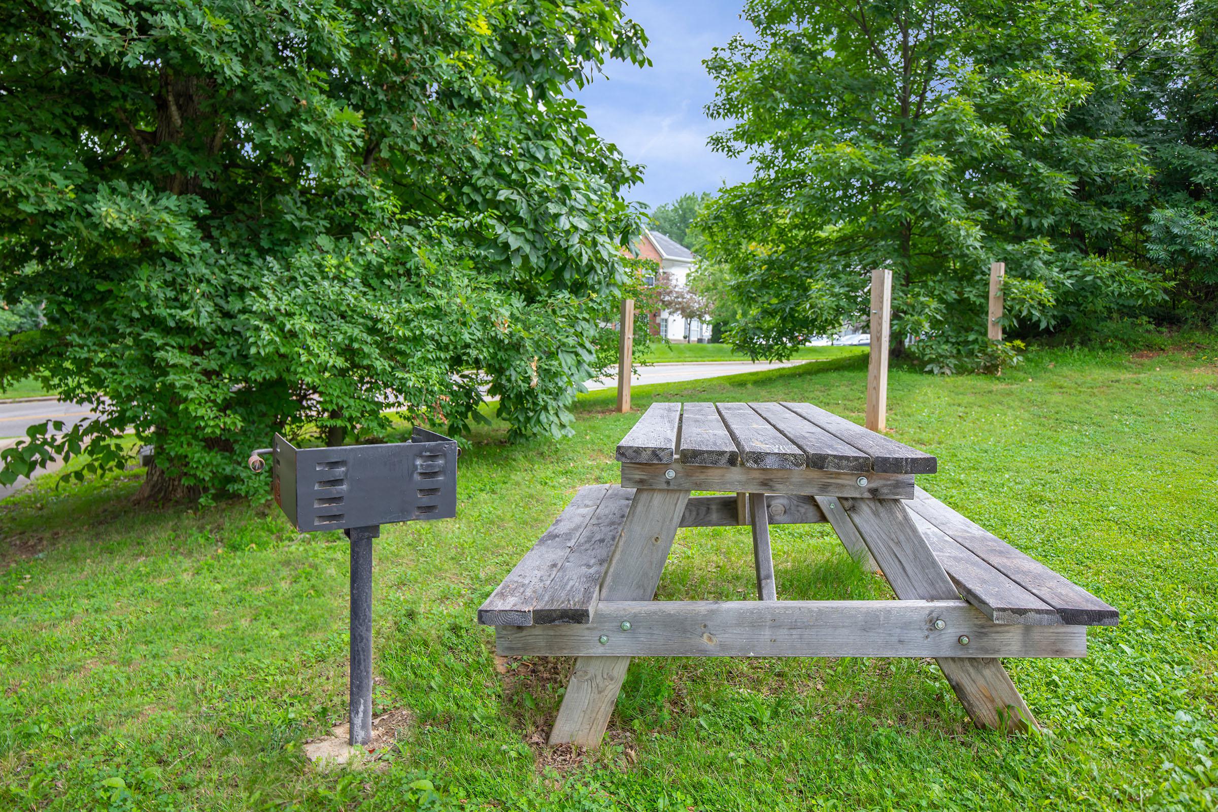 a wooden bench sitting on top of a lush green park