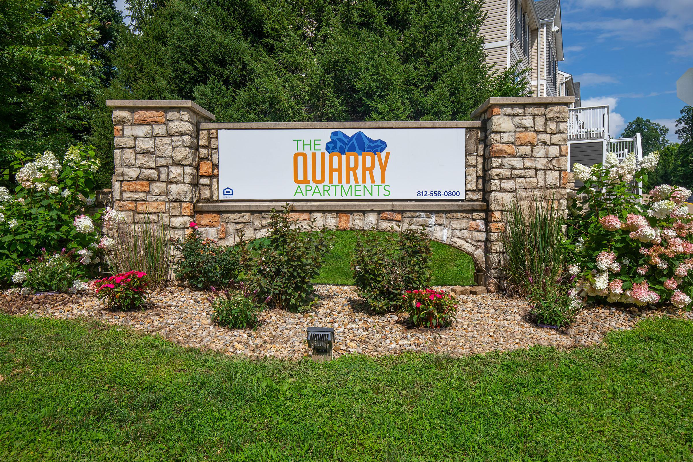 a sign in front of a brick wall