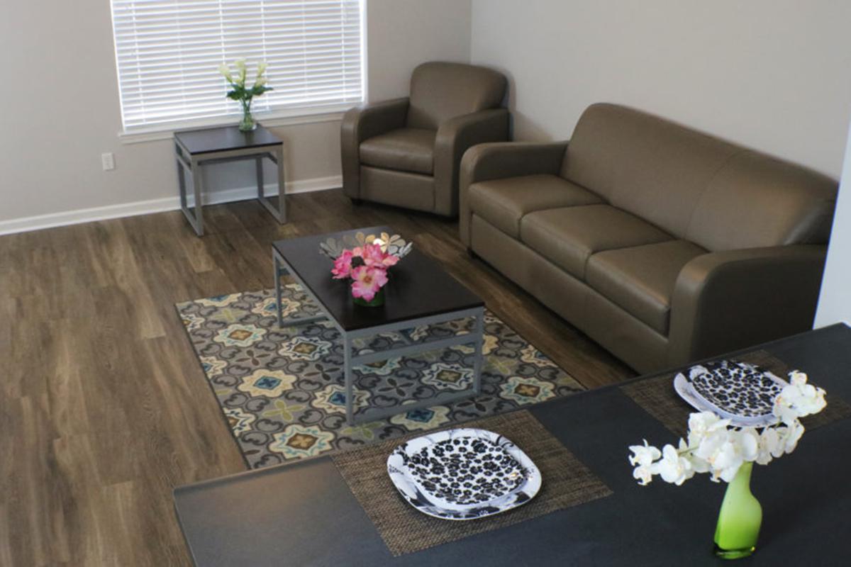 a living room filled with furniture and a coffee table