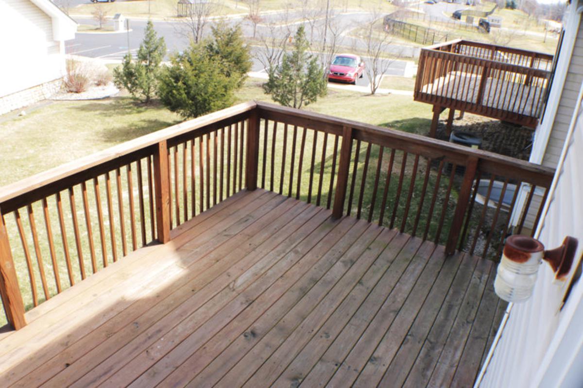 a wooden bench next to a fence