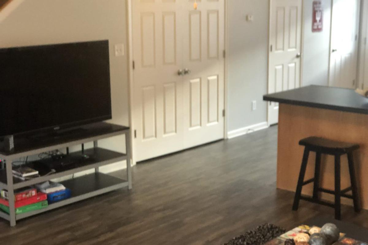 a living room filled with furniture and a flat screen tv