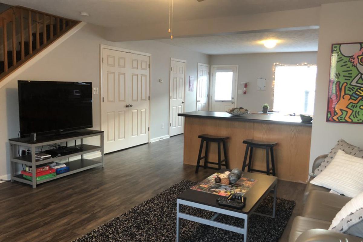 a living room filled with furniture and a flat screen tv