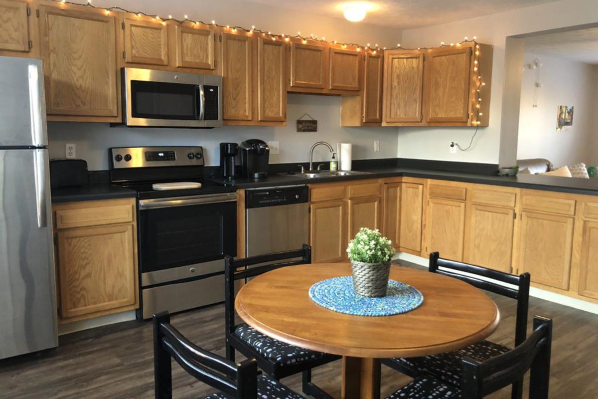 a modern kitchen with stainless steel appliances and wooden cabinets