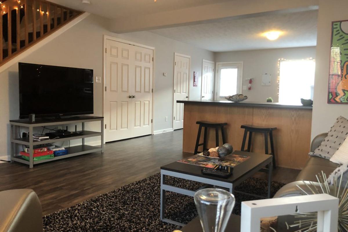 a living room filled with furniture and a flat screen tv