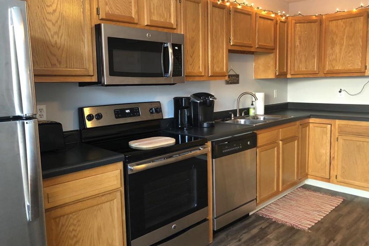 a kitchen with stainless steel appliances and wooden cabinets