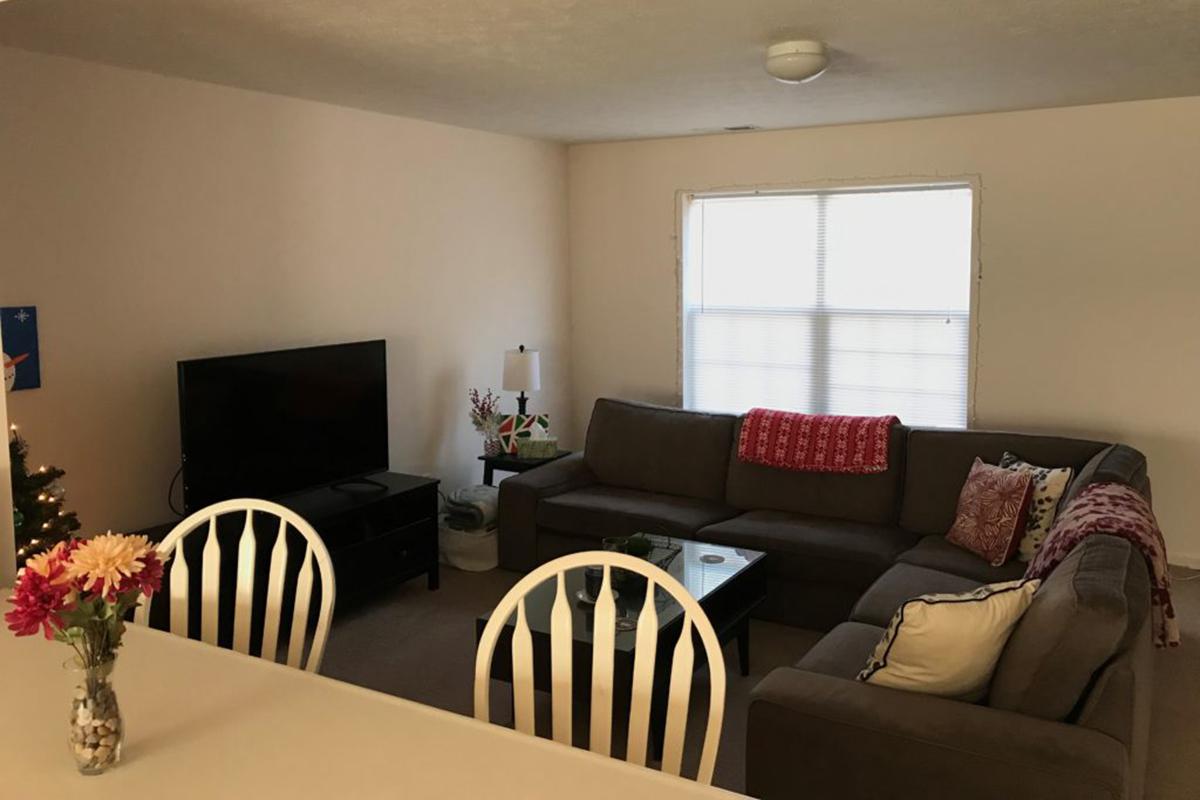 a living room filled with furniture and a fire place and a dining table