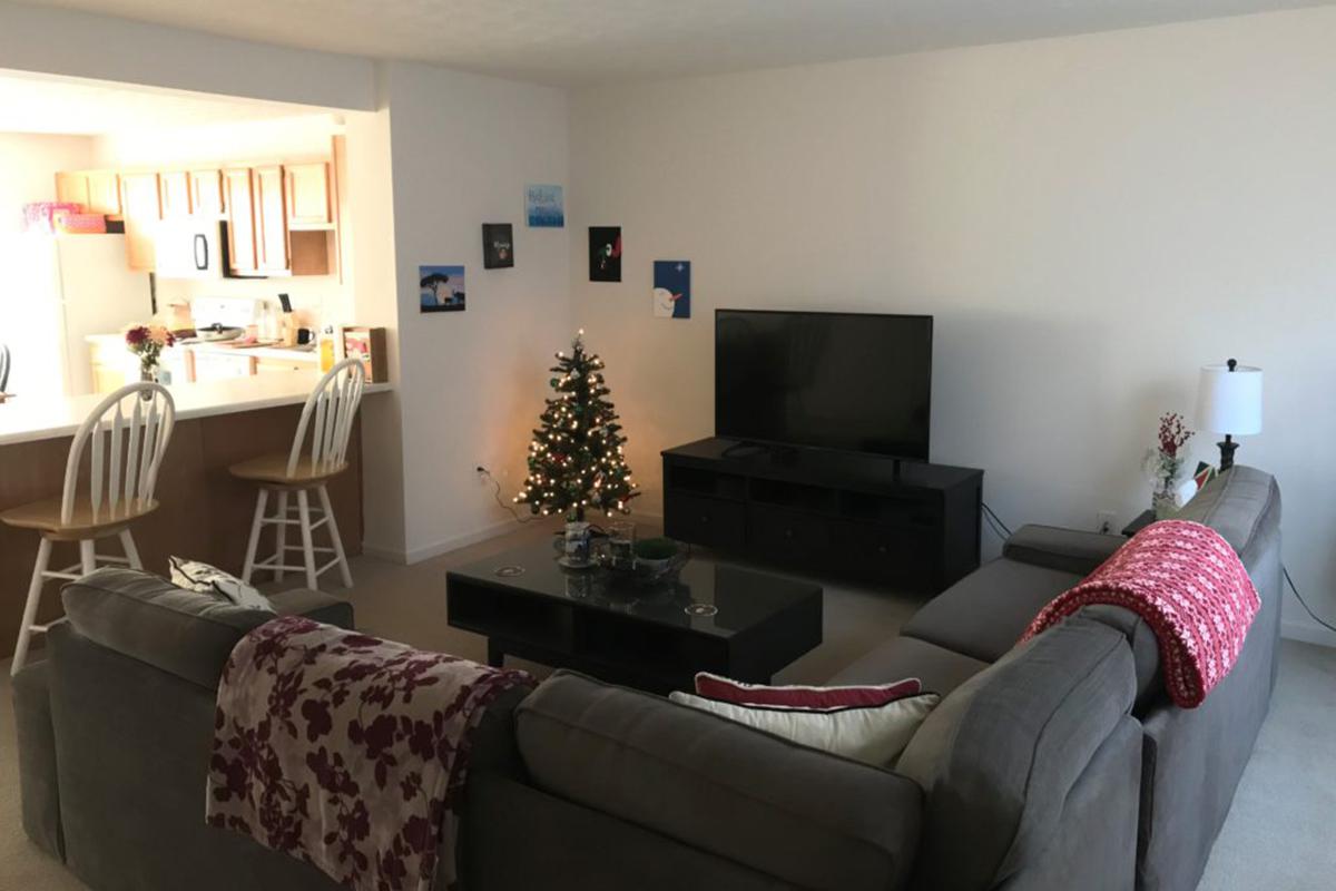 a living room filled with furniture and a flat screen tv