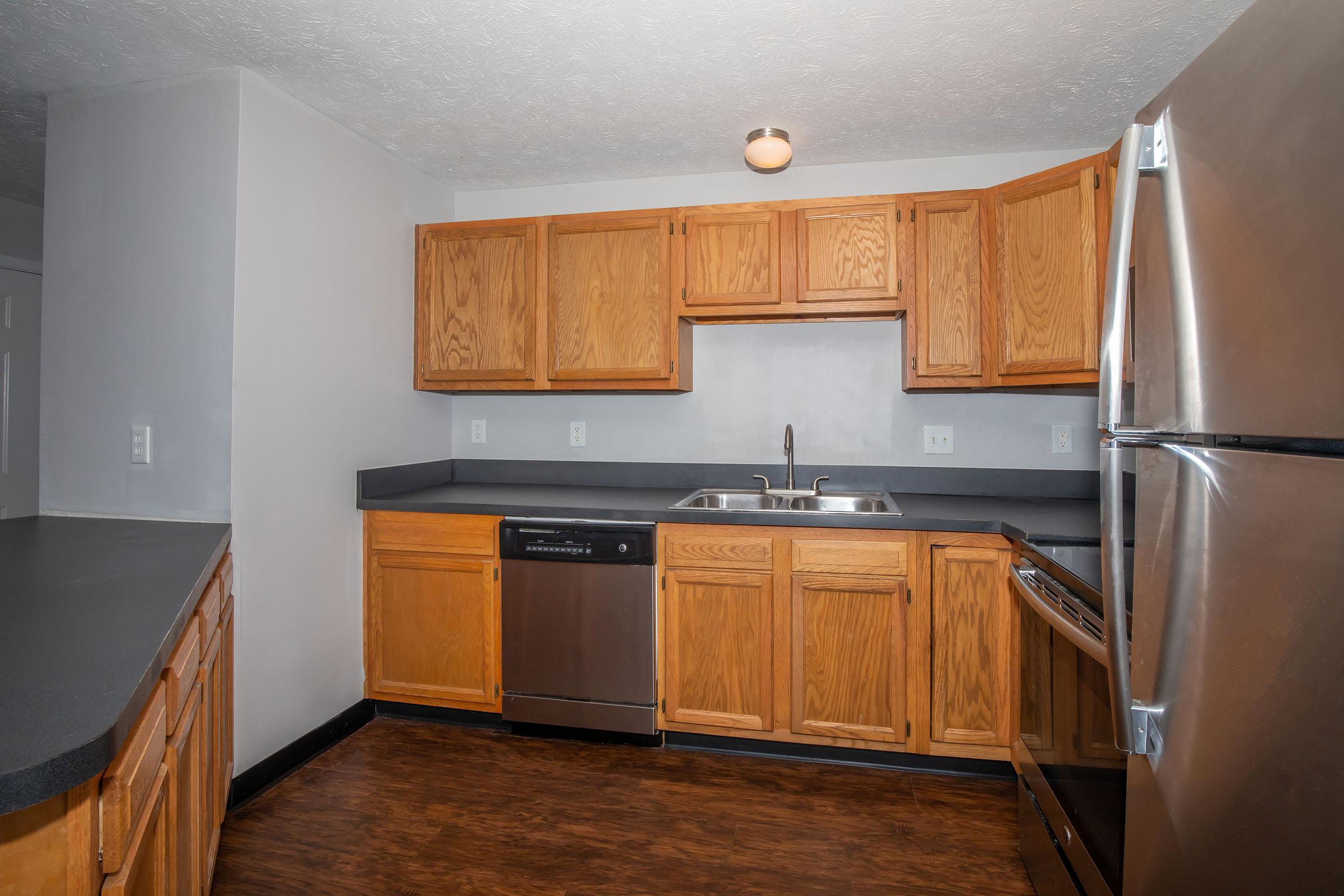 a kitchen with stainless steel appliances and wooden cabinets