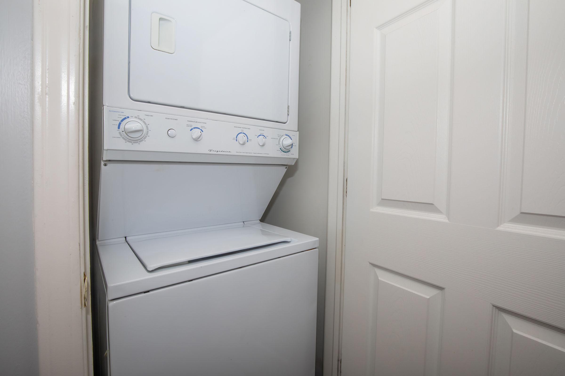 a microwave oven sitting on top of a refrigerator