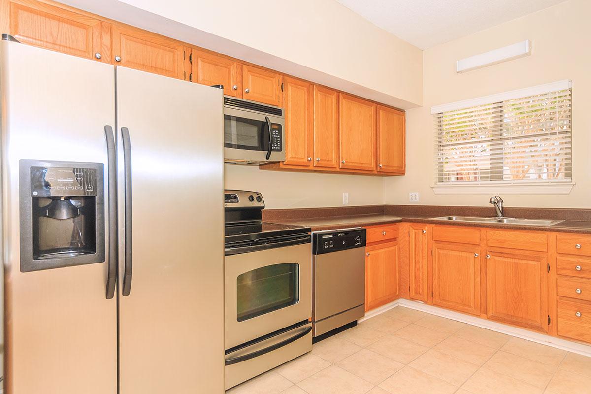 a kitchen with stainless steel appliances and wooden cabinets