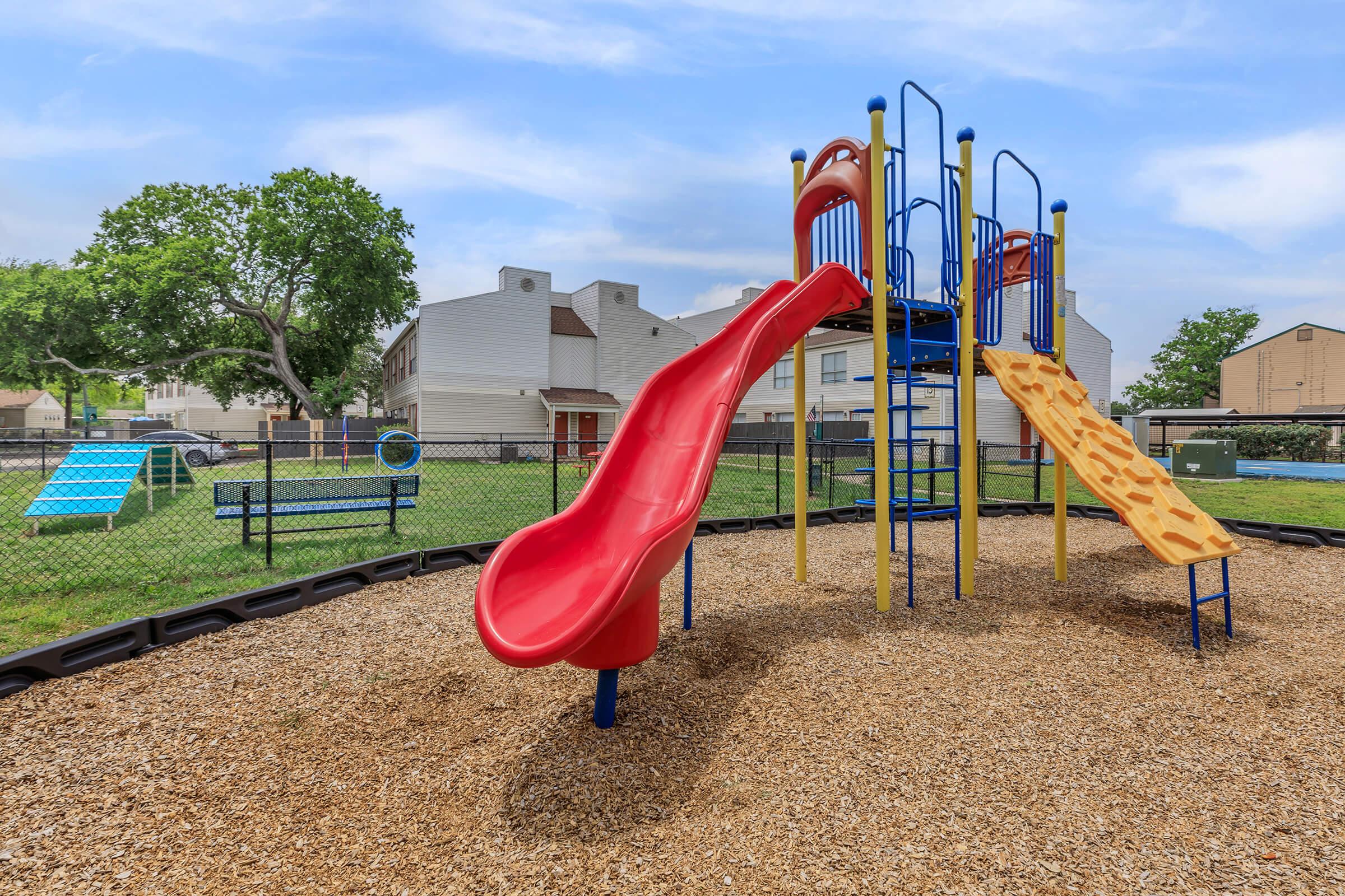 a playground in front of a fence