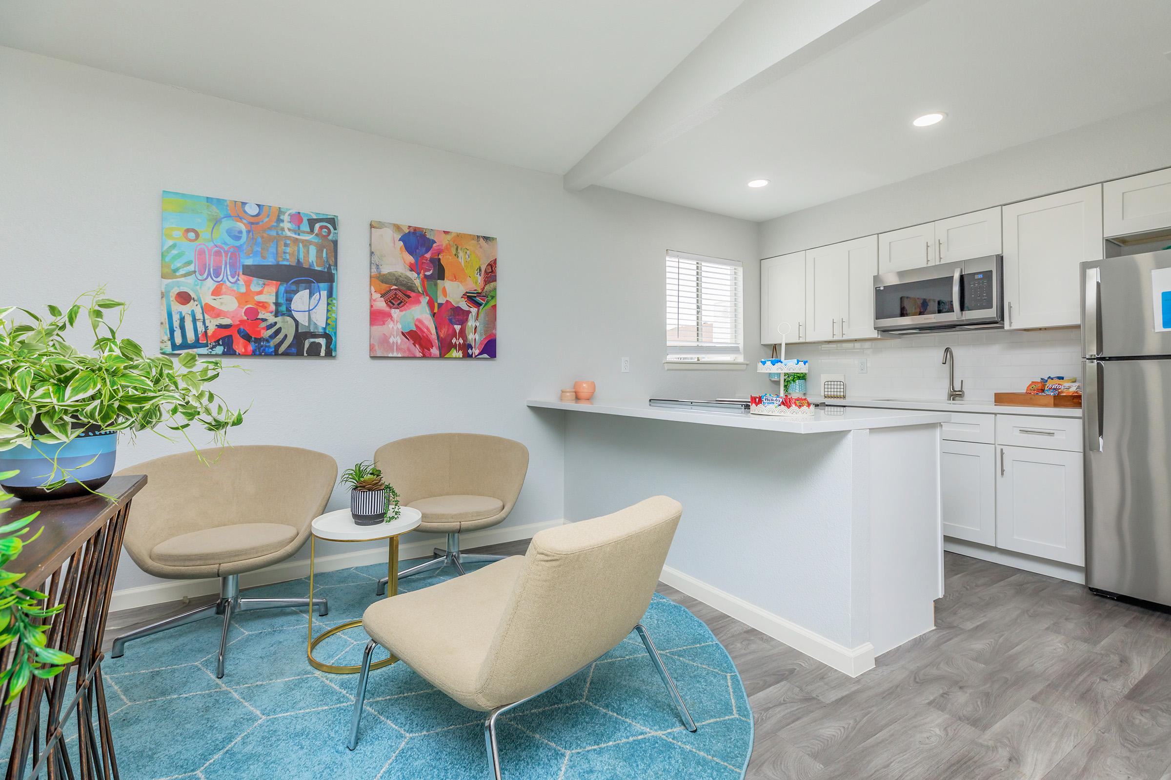 a living room filled with furniture and a refrigerator