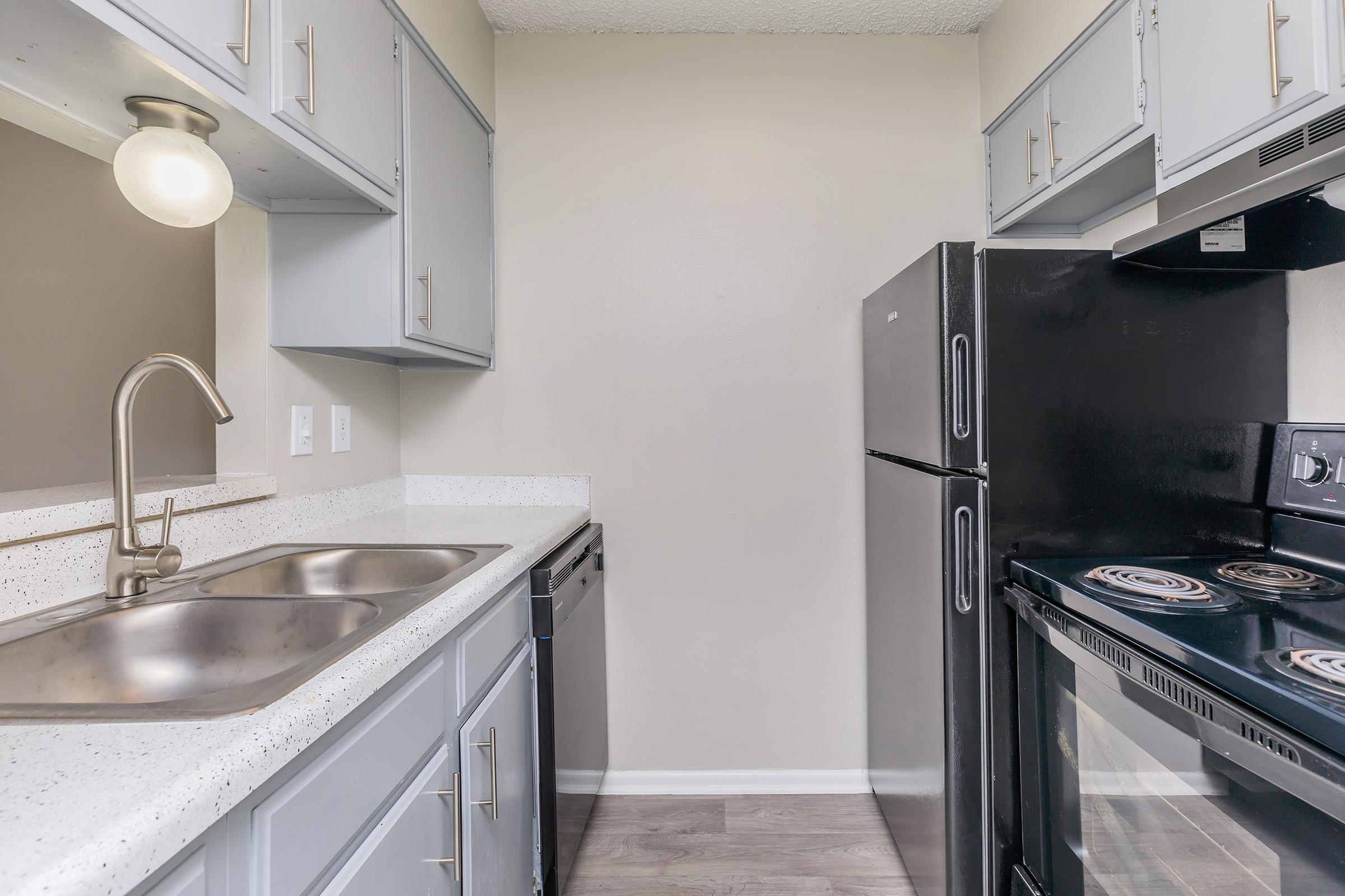 a kitchen with a stove and a sink