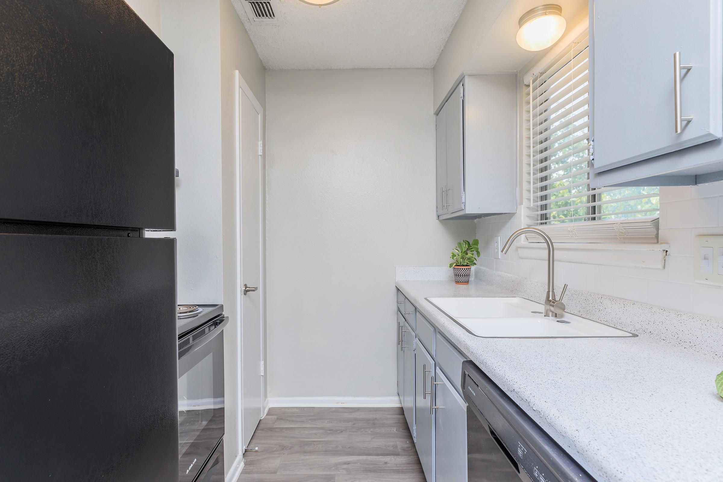 a kitchen with a sink and a refrigerator