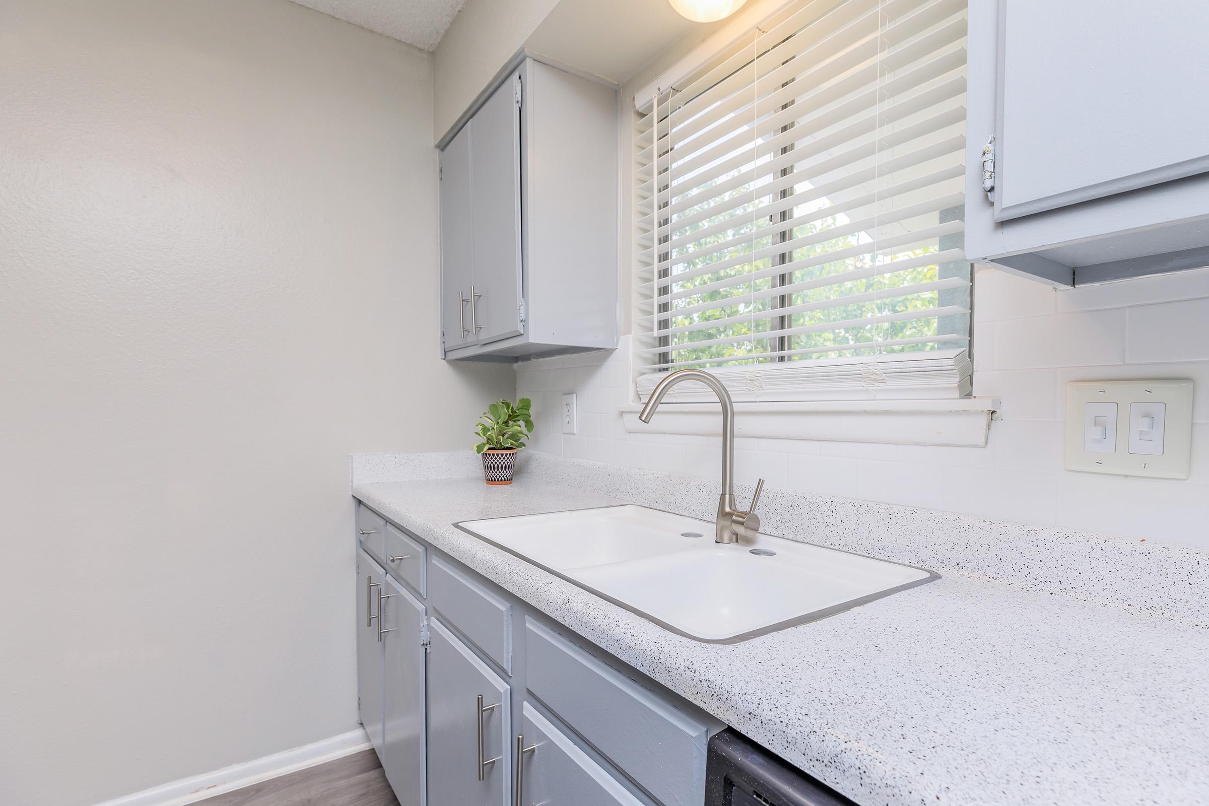 a kitchen with a sink and a window