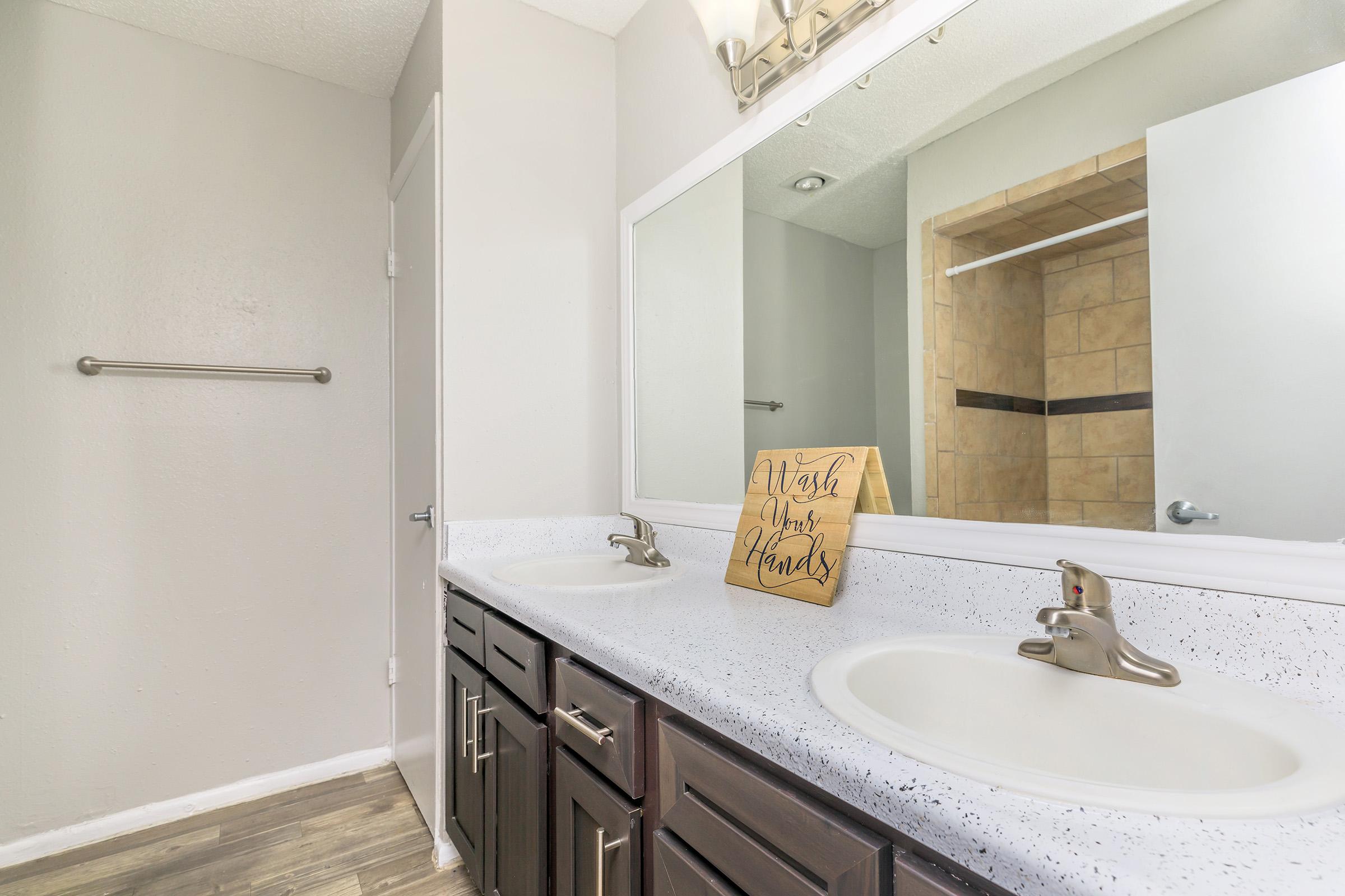 a kitchen with a sink and a mirror