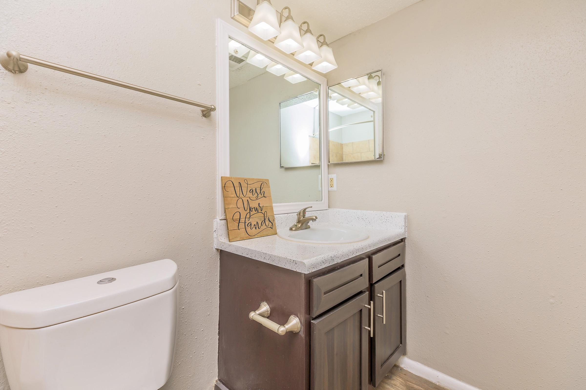 a room with a sink and a mirror