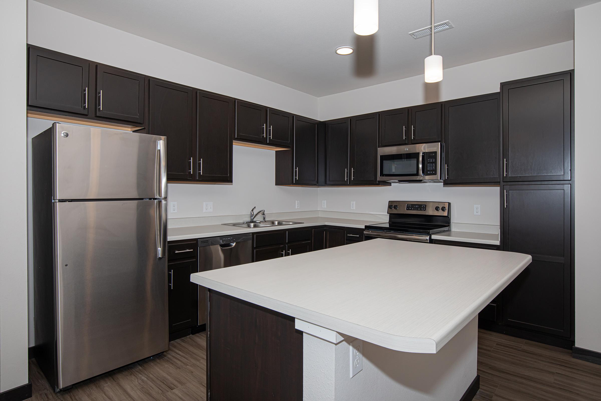 a kitchen with a sink and a refrigerator