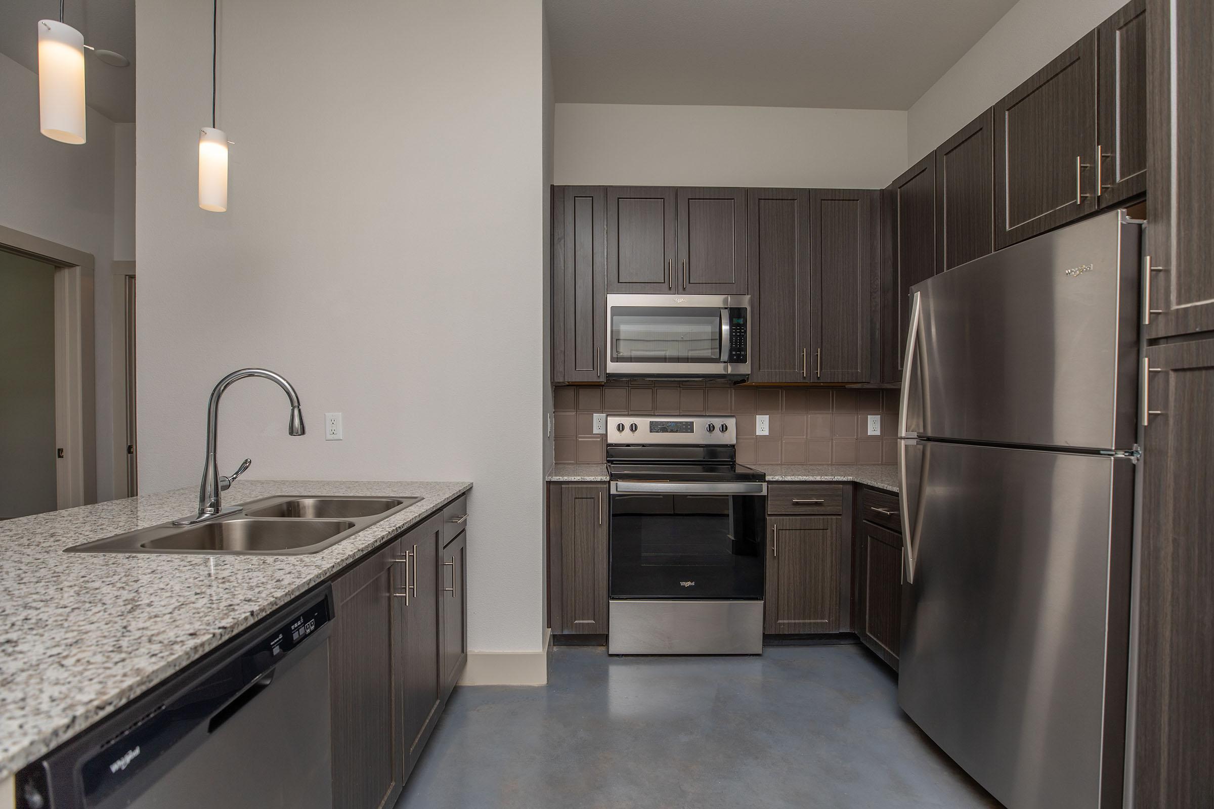 a large kitchen with stainless steel appliances