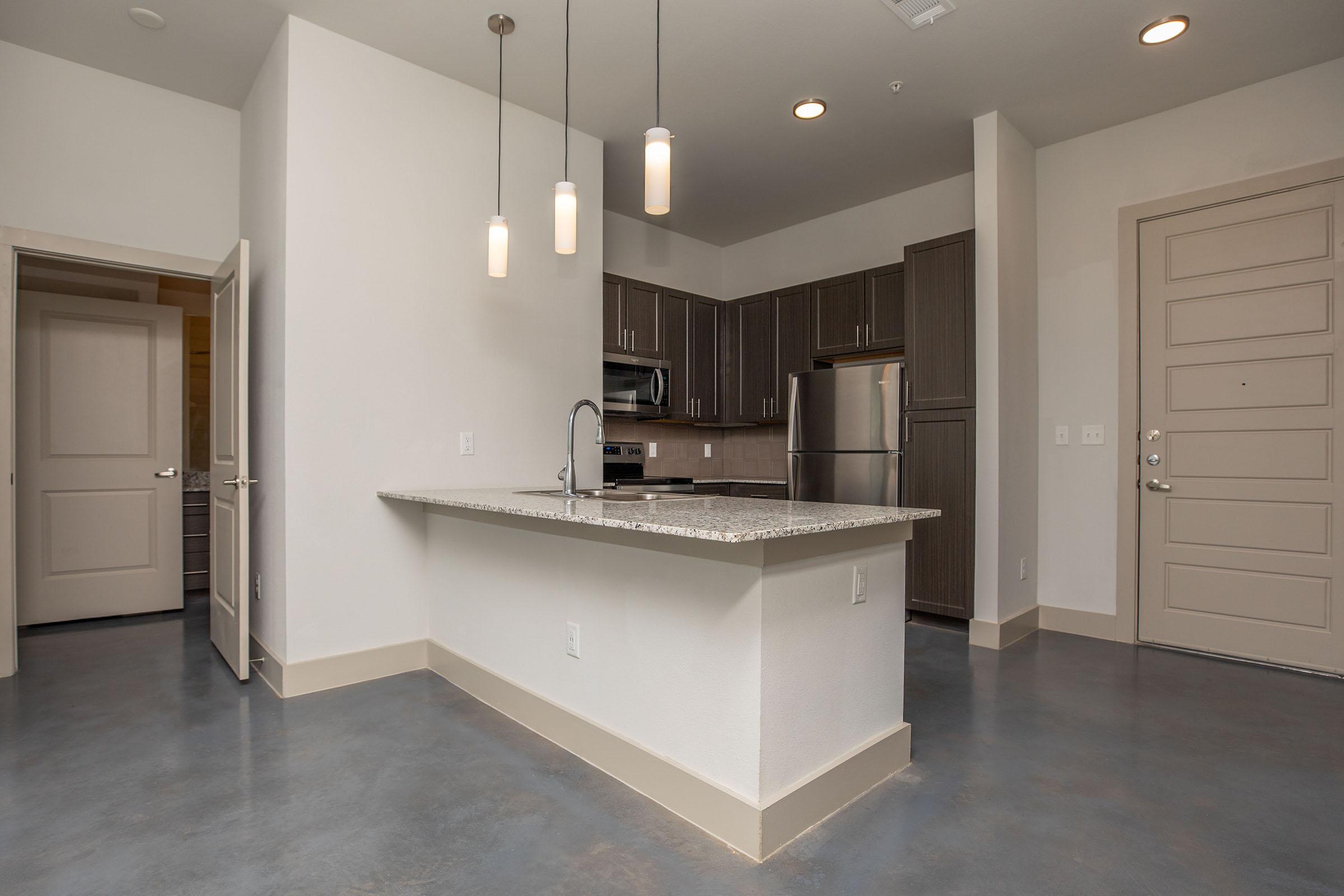 a kitchen with a sink and a refrigerator