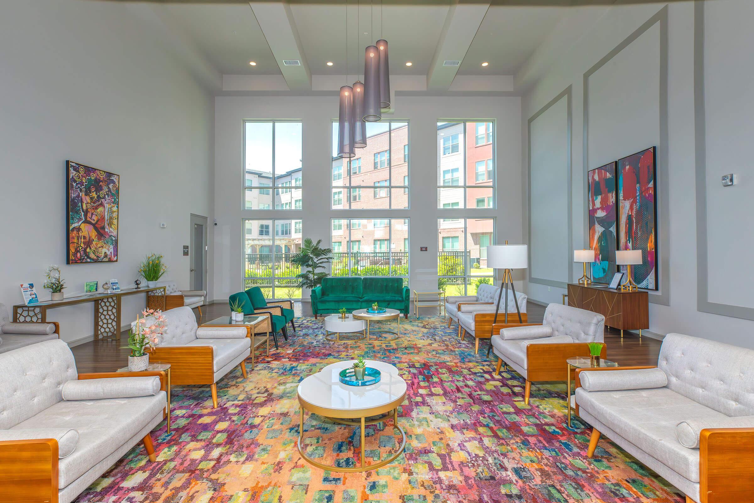 a living room filled with furniture and vase of flowers on a table