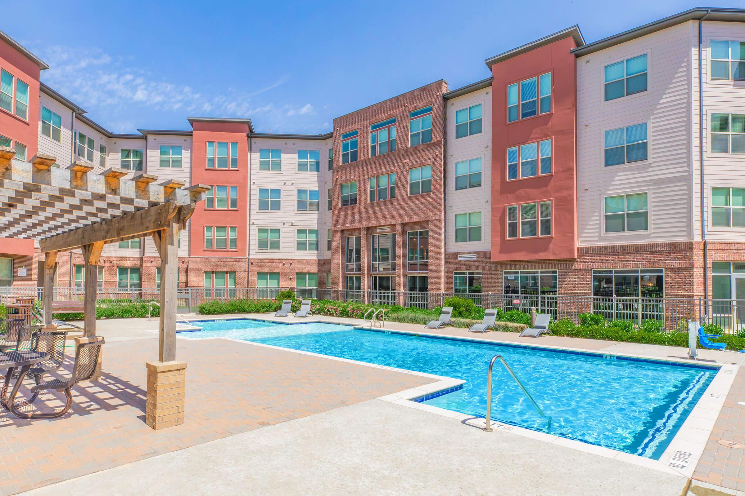 a large brick building with a pool