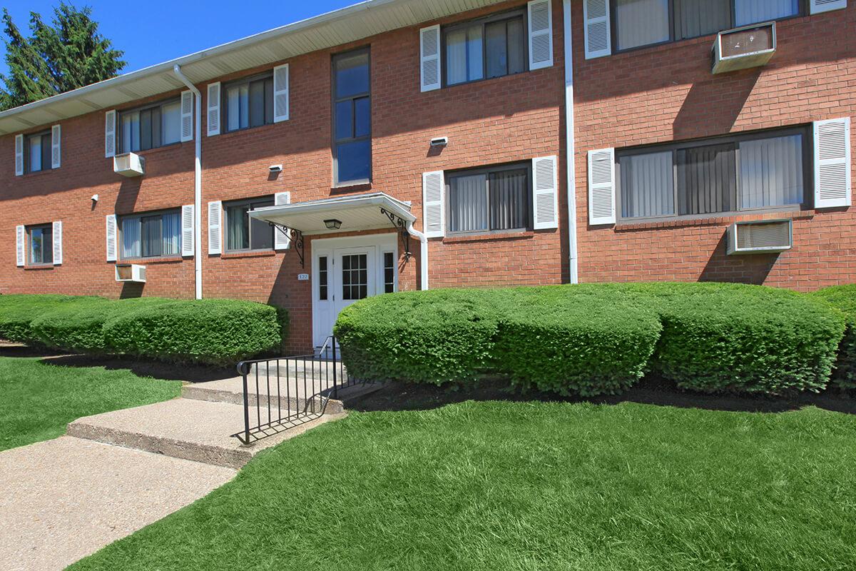 a large lawn in front of a brick building